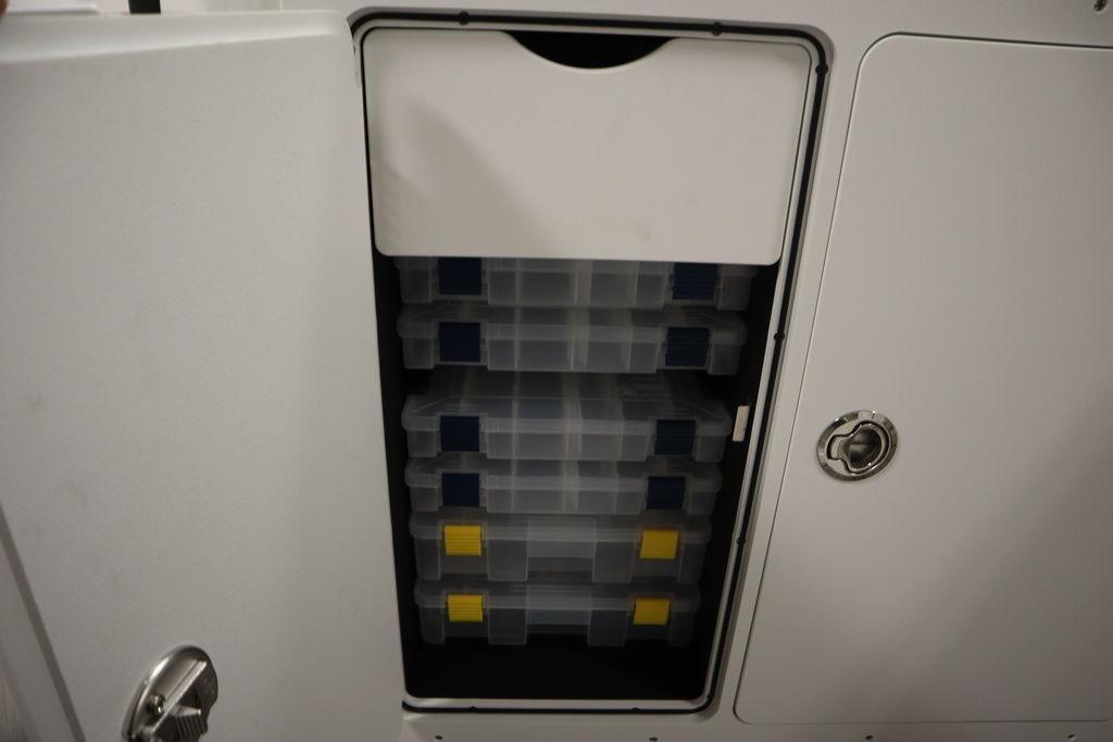Storage compartment with tackle boxes on a 2026 Yamaha Boats 255 FSH Sport E.