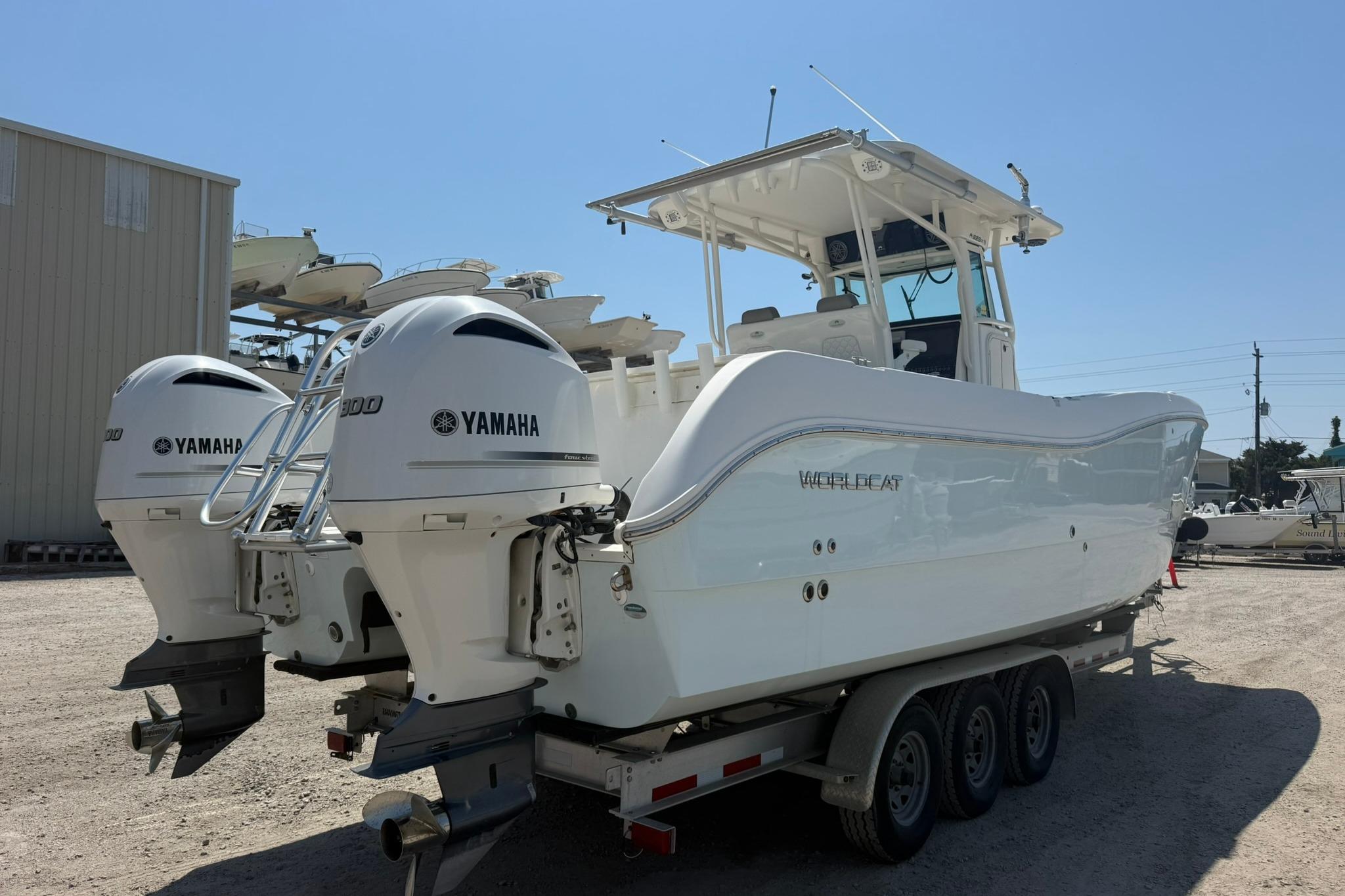 2020 World Cat 325 CC boat with twin Yamaha engines on a trailer.