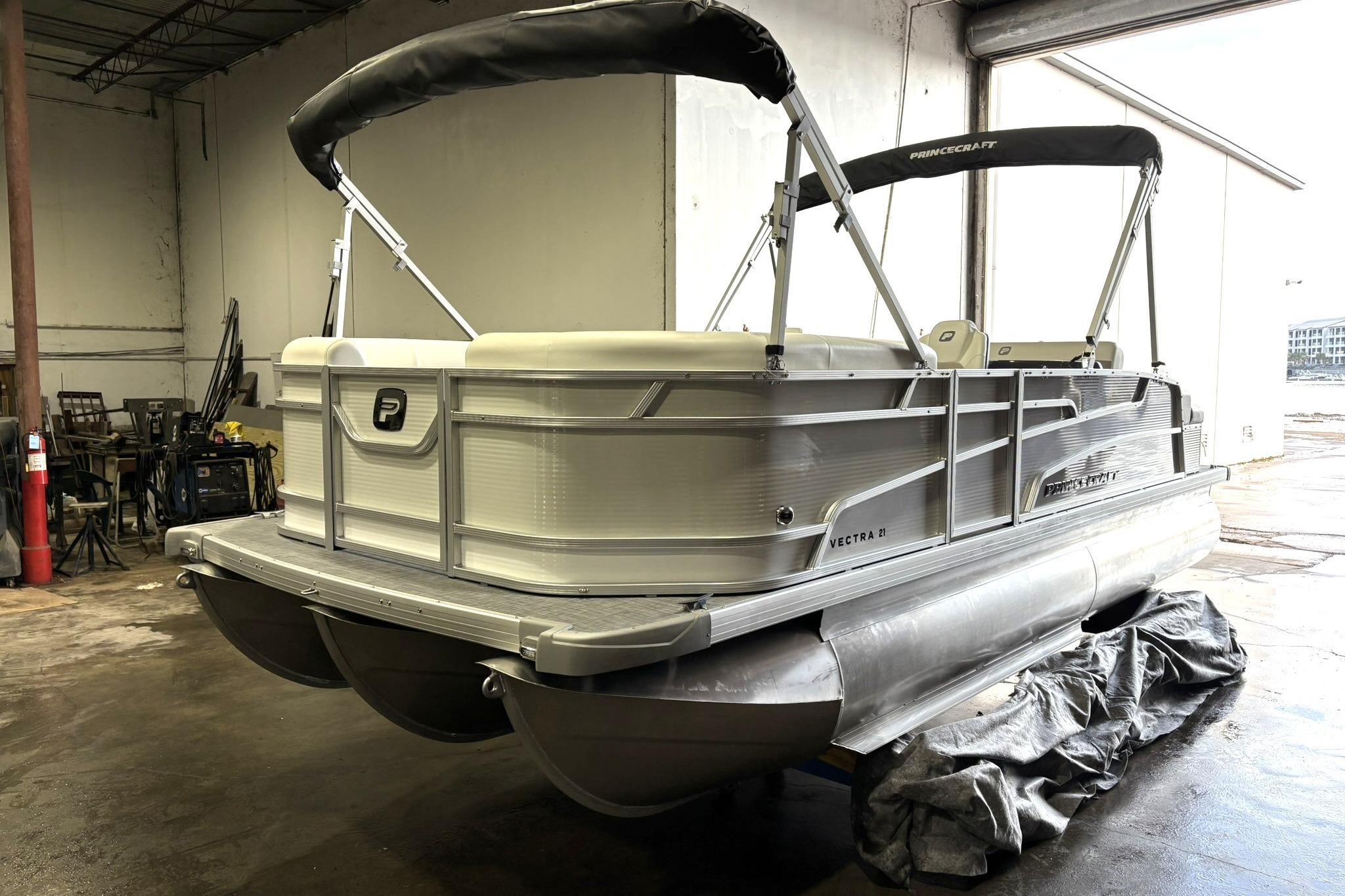 2025 Princecraft Vectra 21 RL pontoon boat in a warehouse setting.
