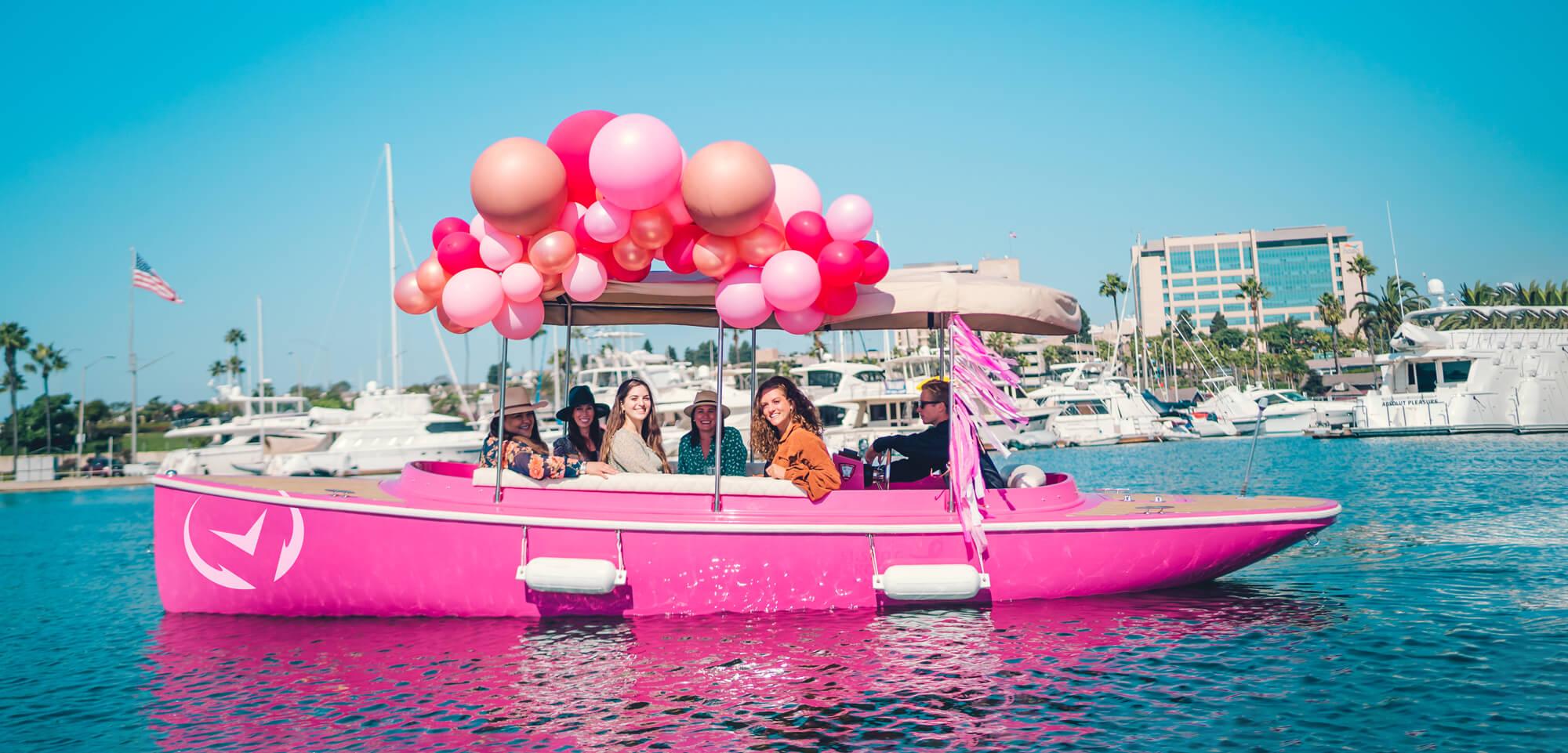 Pink Vision Marine Fantail 217 boat with balloons, cruising in a marina, 2023 model.