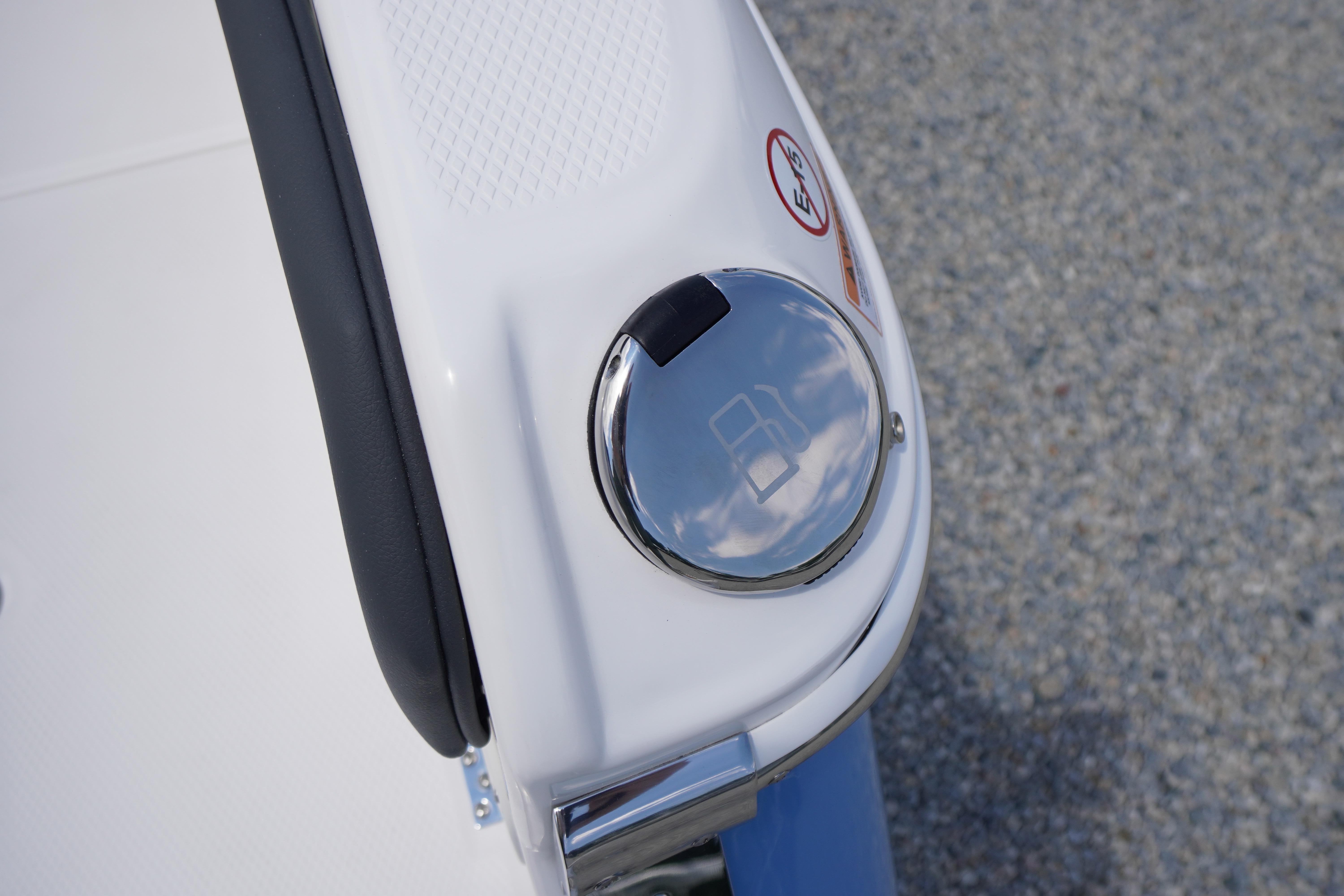 Fuel cap on 2026 Chaparral SSX 4 boat, reflecting sky and clouds.