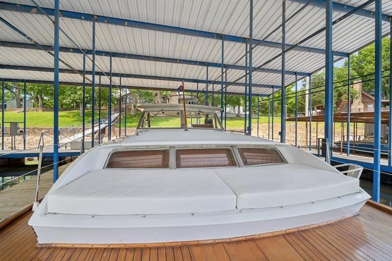 1964 Chris-Craft 37 Constellation docked under covered marina, showcasing classic design.