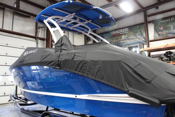 2025 Cobalt R6 boat with cover in a garage setting.
