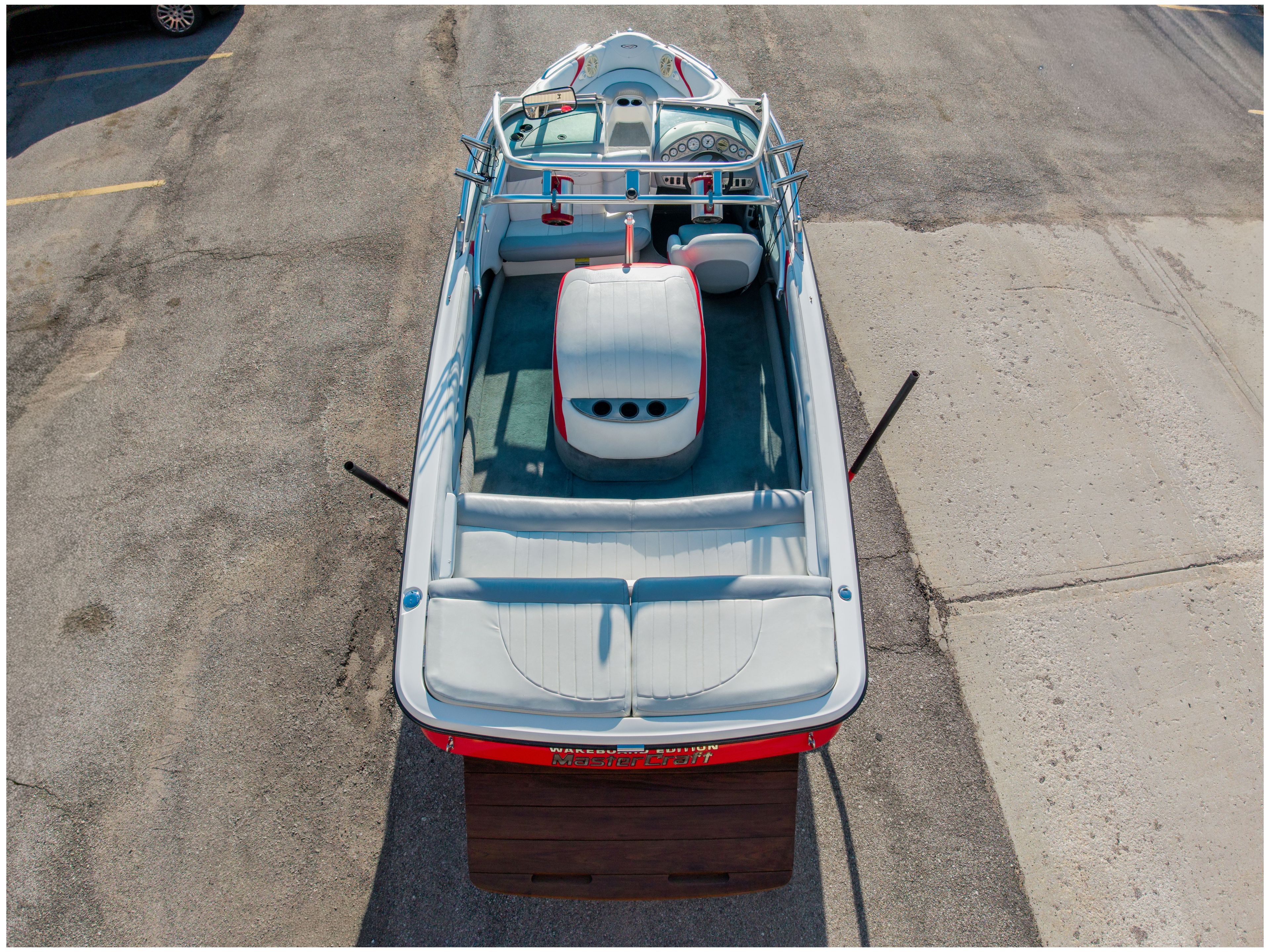 Aerial view of a 2002 MasterCraft X-7 boat on asphalt.