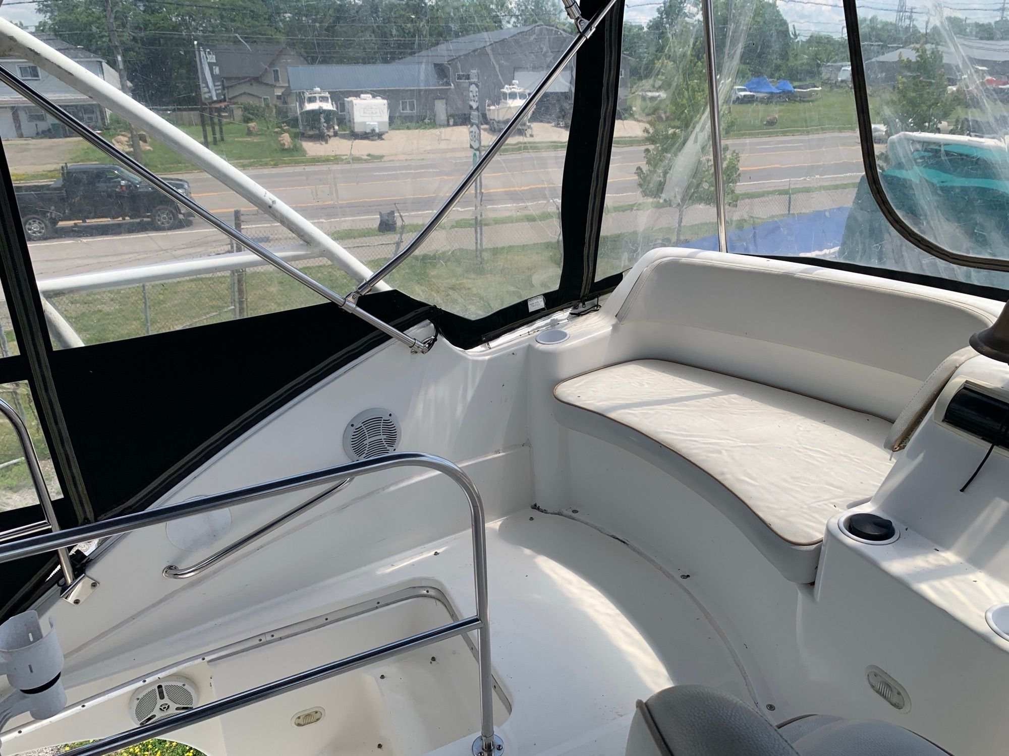 The image shows the cockpit of a Silverton 33 Convertible boat with seating area and railing.
