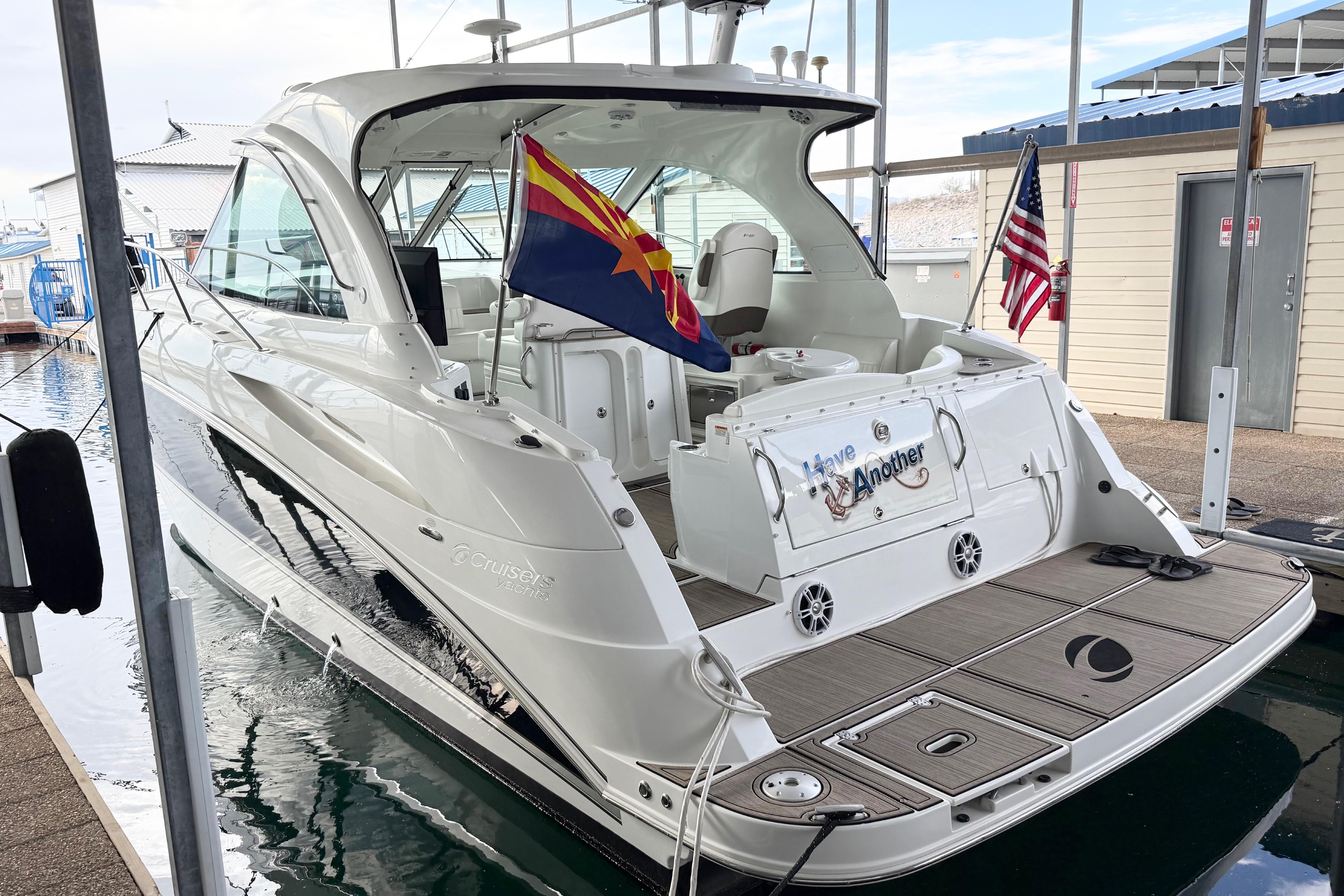 2011 Cruisers Yachts 390 Sports Coupe docked with flags displayed.