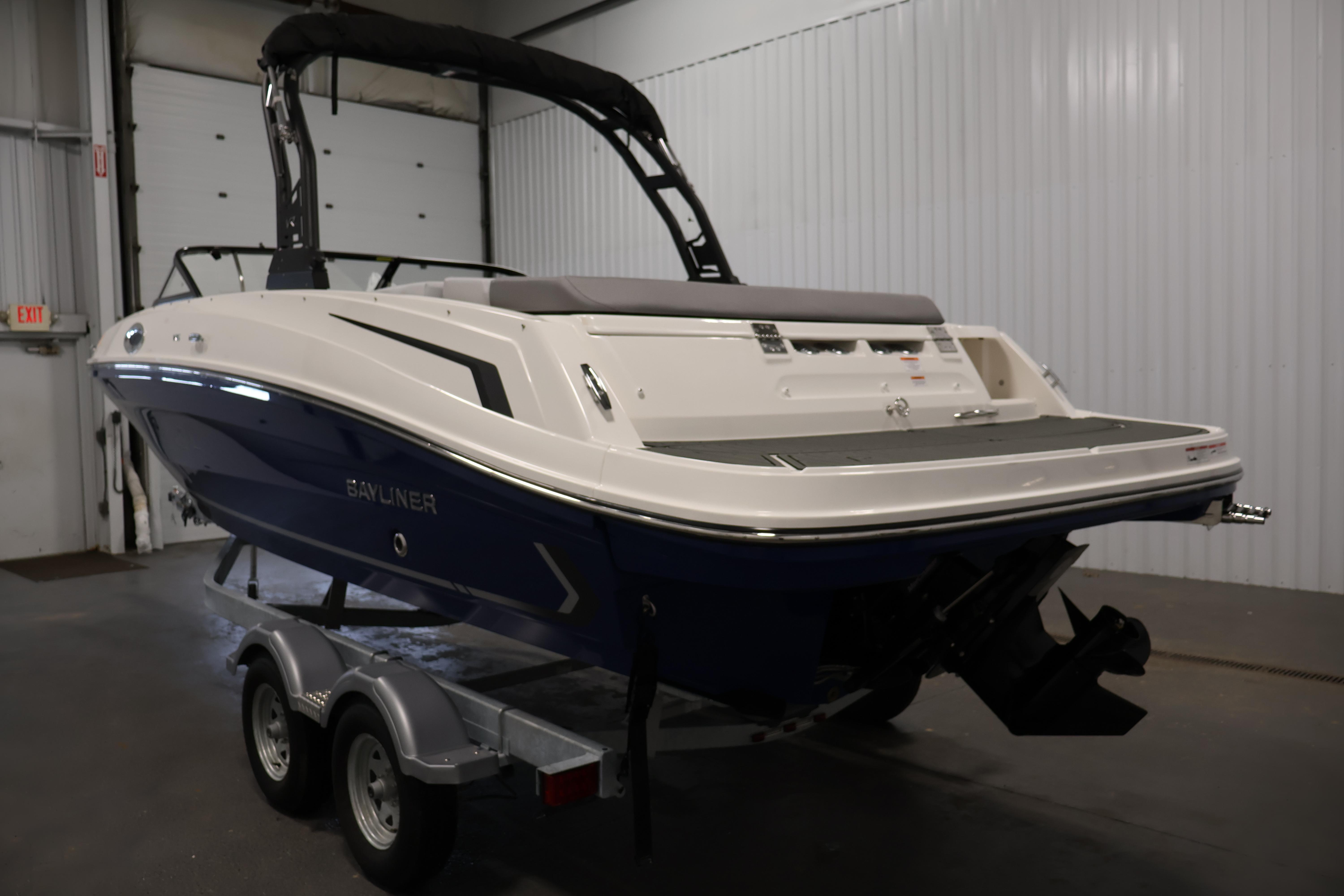 2026 Bayliner VR6 Bowrider I/O boat on trailer in indoor storage.