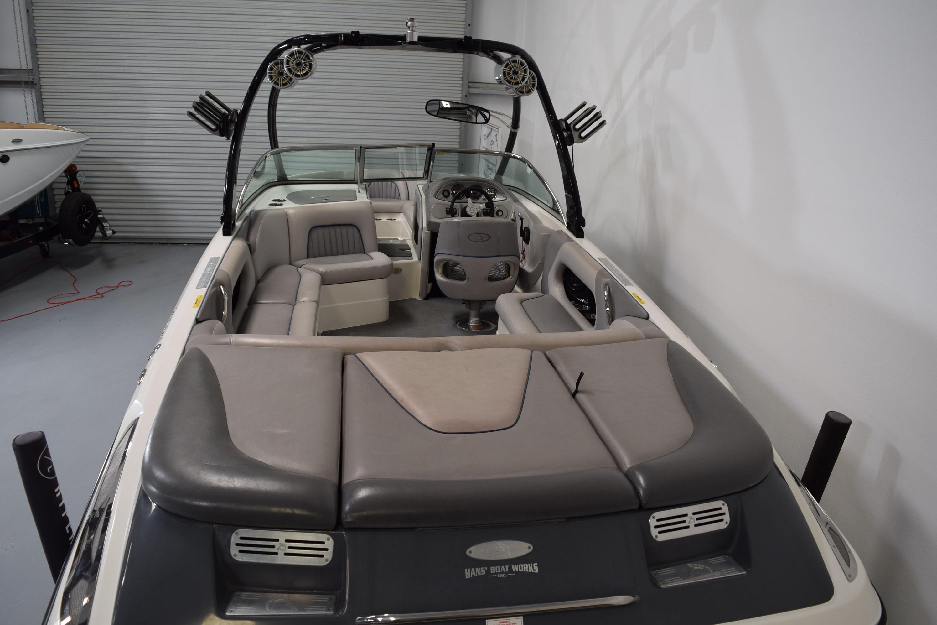 2007 Centurion SV 240 boat interior with seating and steering wheel in a garage setting.