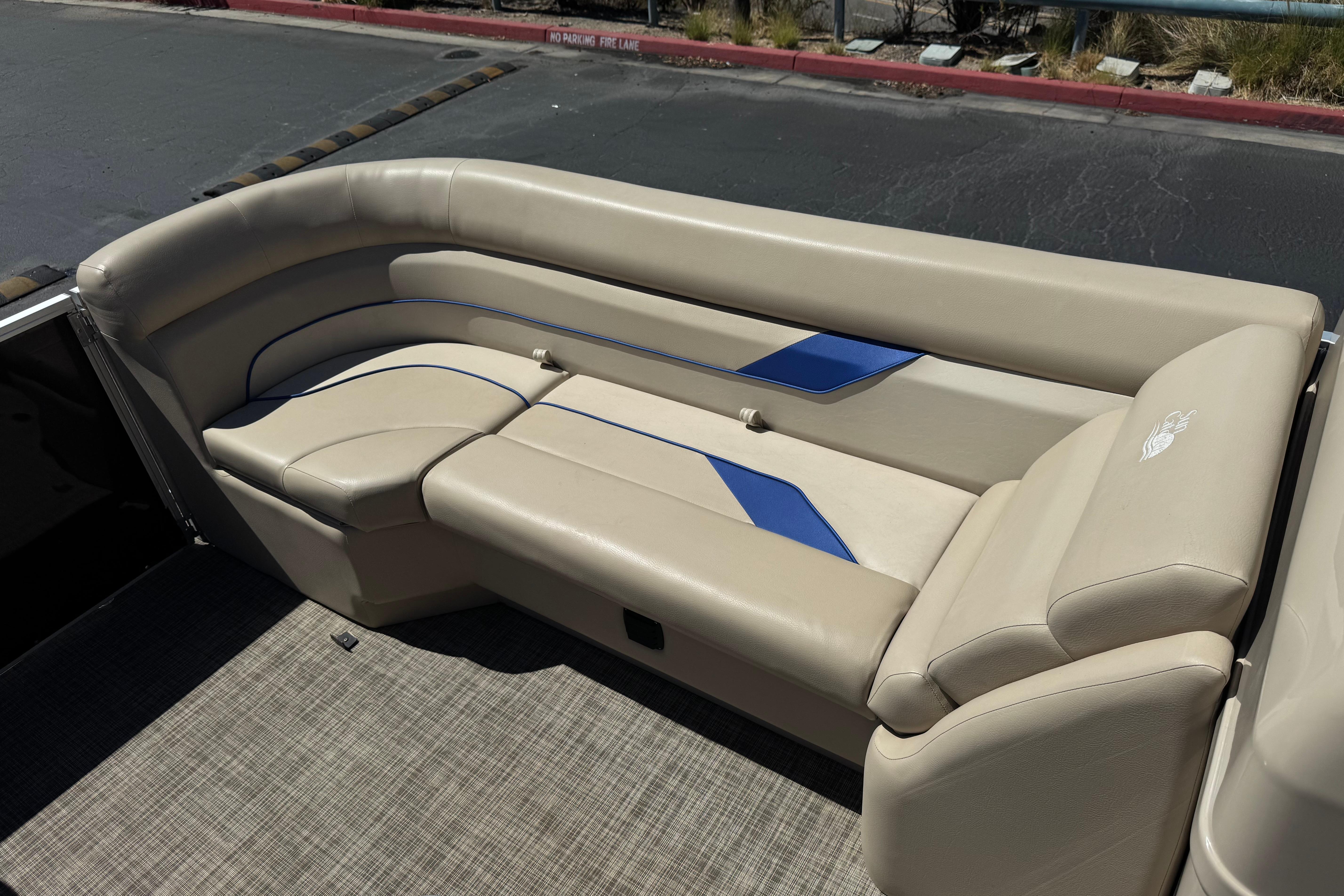 2021 SunCatcher Select 20RCX boat seating with beige upholstery and blue accents.