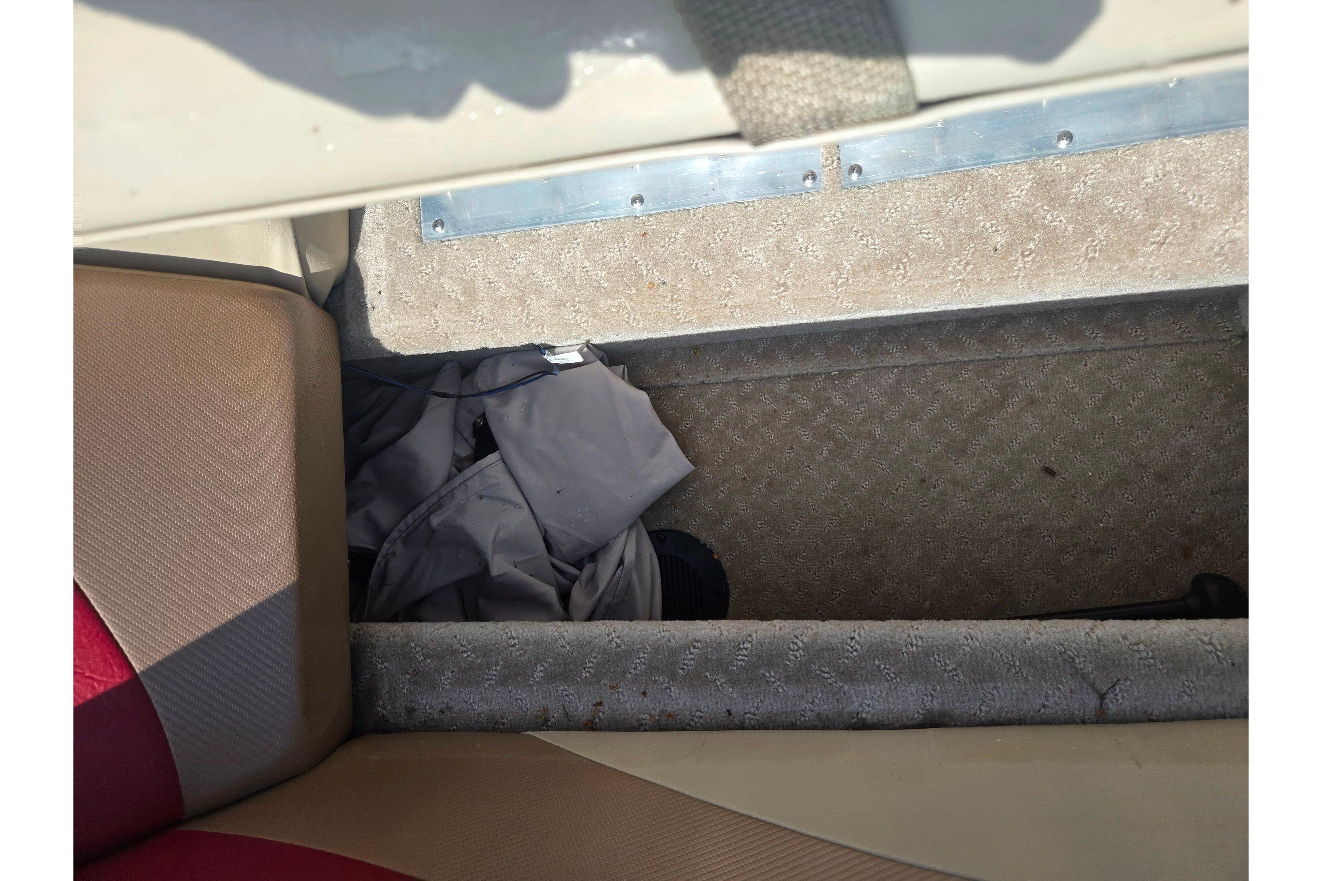 Interior view of a 2015 Lowe Sport Deck 224 boat, showing seating and storage area.