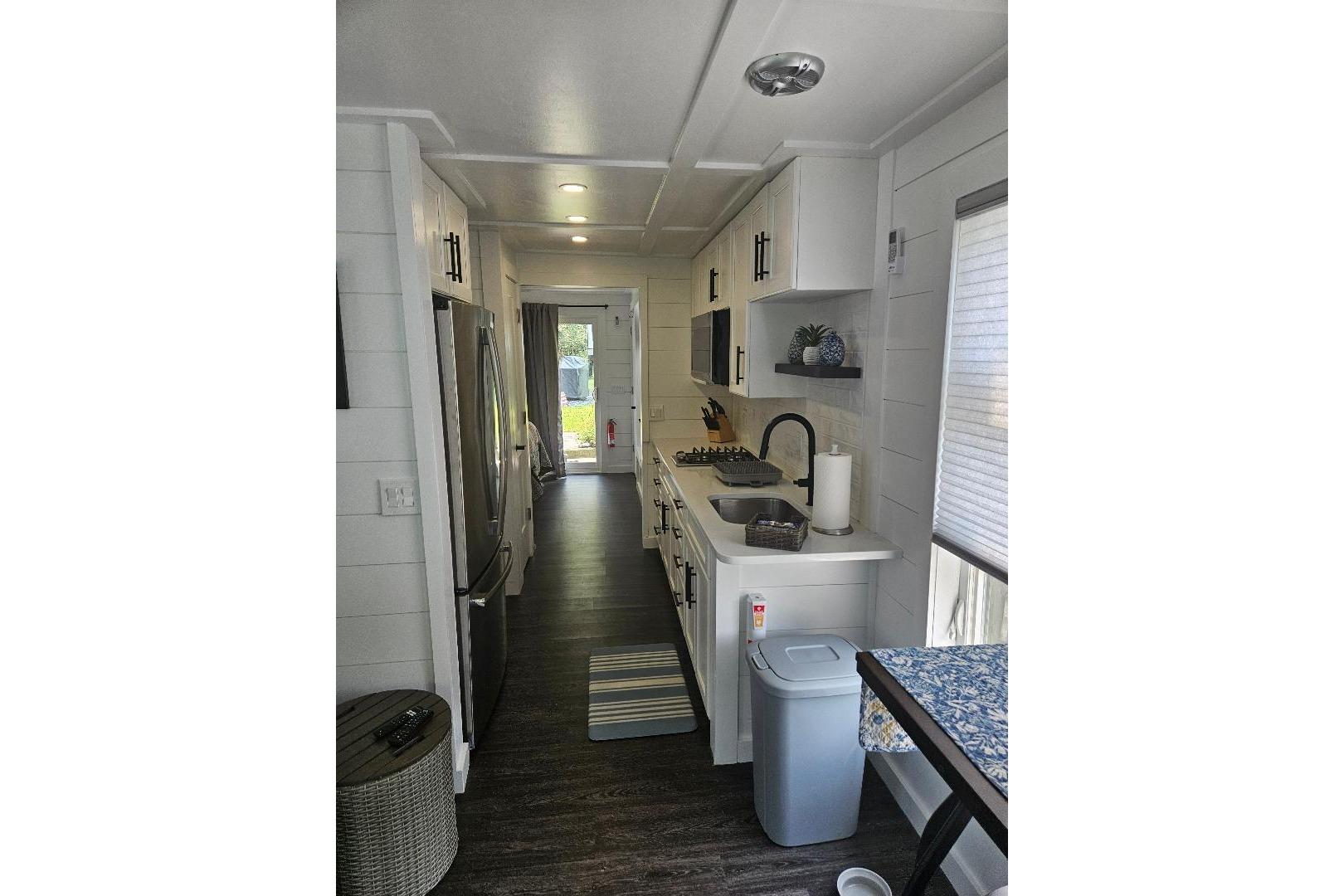 Modern kitchen interior of 2021 East Coast Houseboats Freedom 40, featuring sleek appliances and cabinetry.