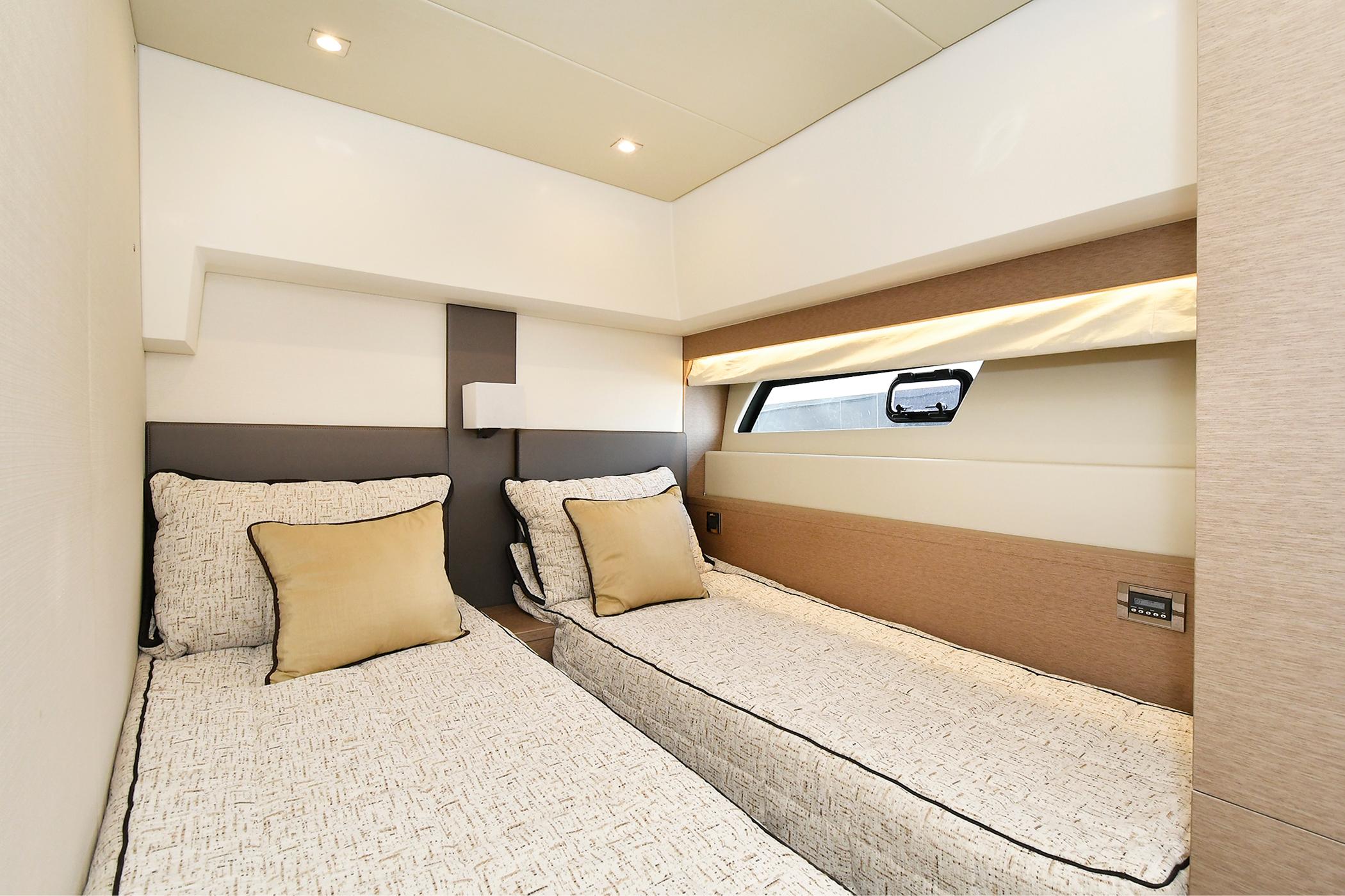 Luxurious twin cabin interior of 2018 Prestige 560 Fly yacht with modern design.