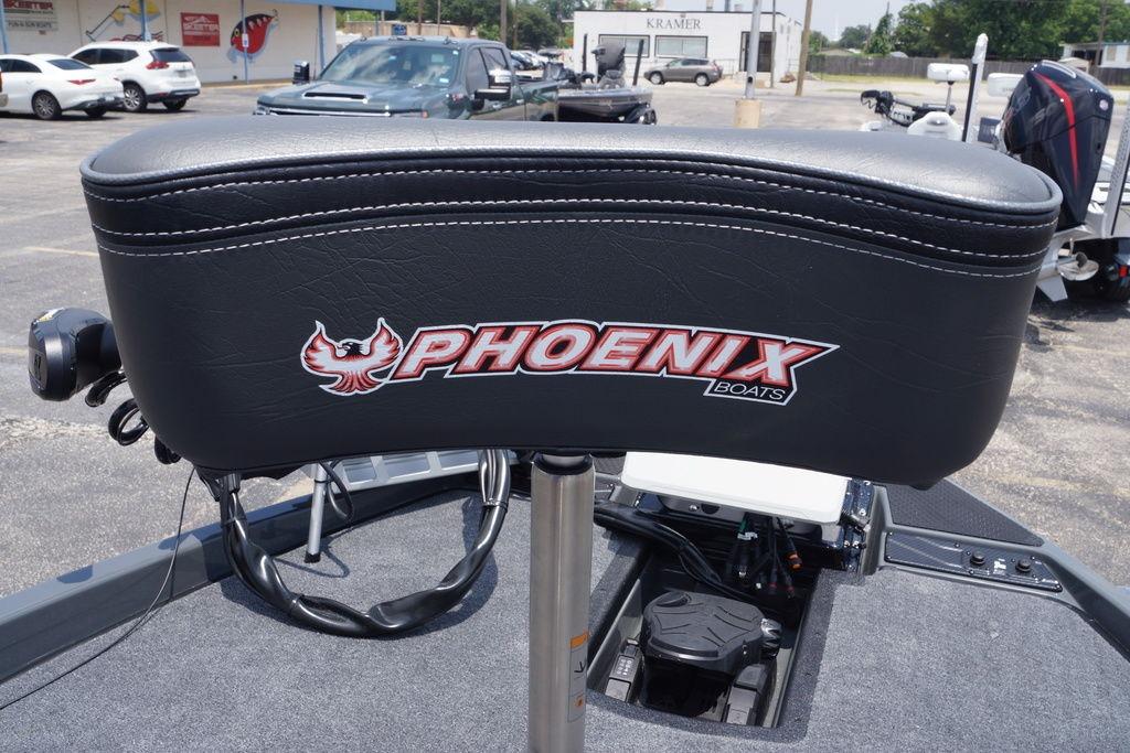 Phoenix 921 Elite X II 2027 boat seat with logo in a parking lot setting.