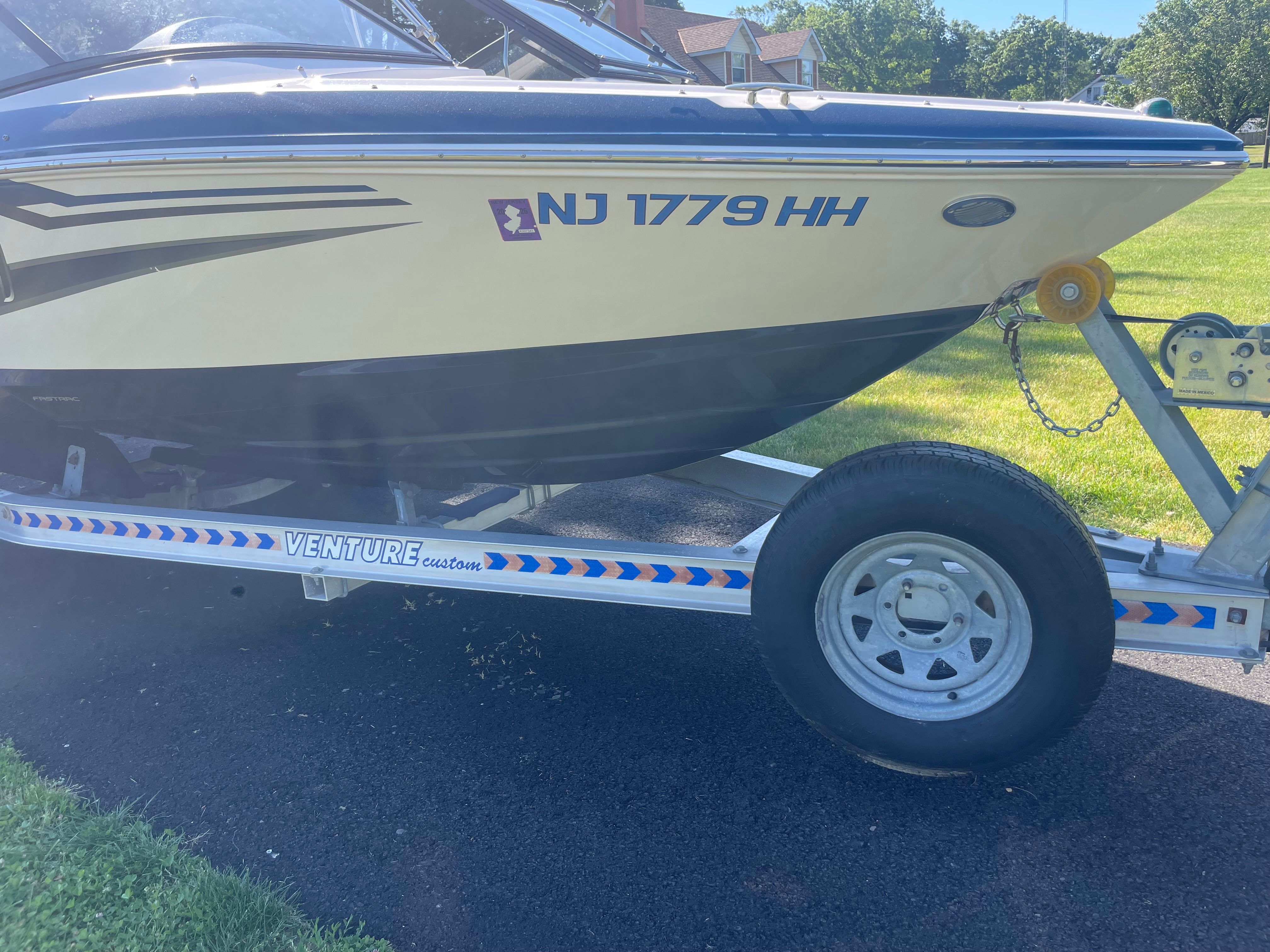 A 2016 Regal 1900 ESX Bowrider on a trailer, parked on a road.