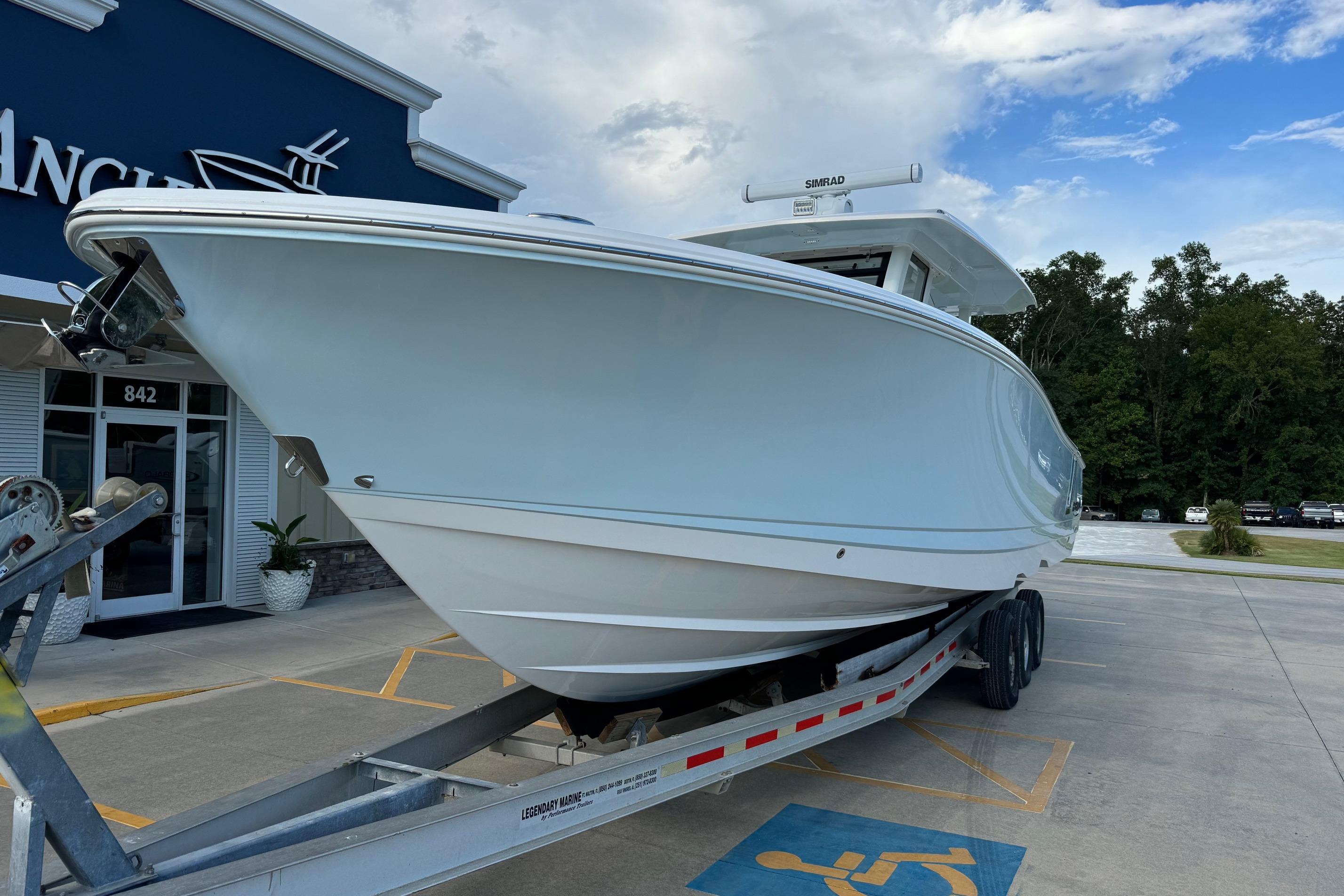 2025 Robalo R360 Center Console boat on trailer outside dealership.