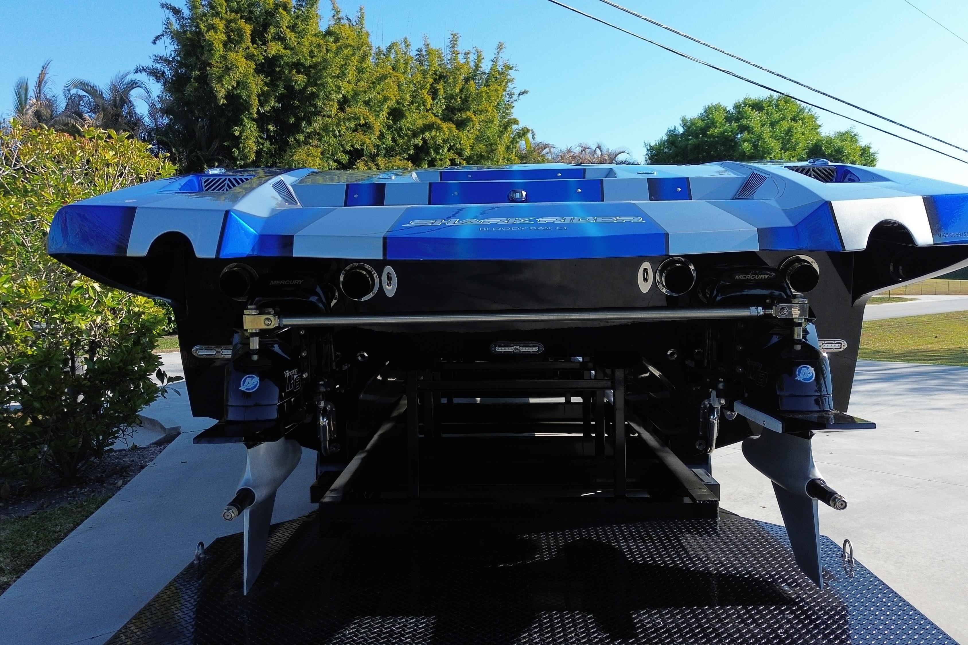 Rear view of a 2016 MTI 44 RP speedboat with dual propellers on a trailer.