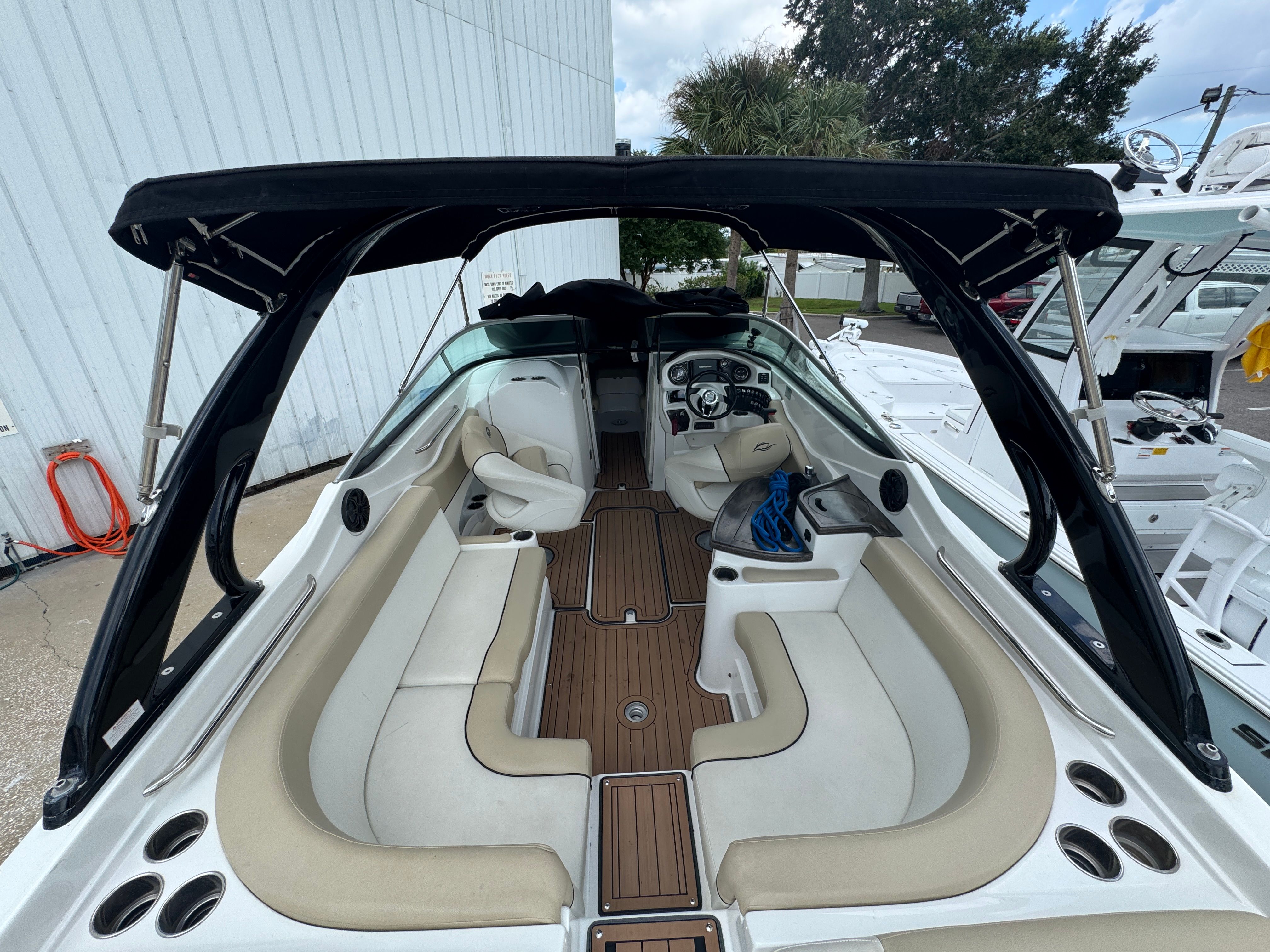 Interior view of a 2017 Rinker QX29 BR boat with seating area.