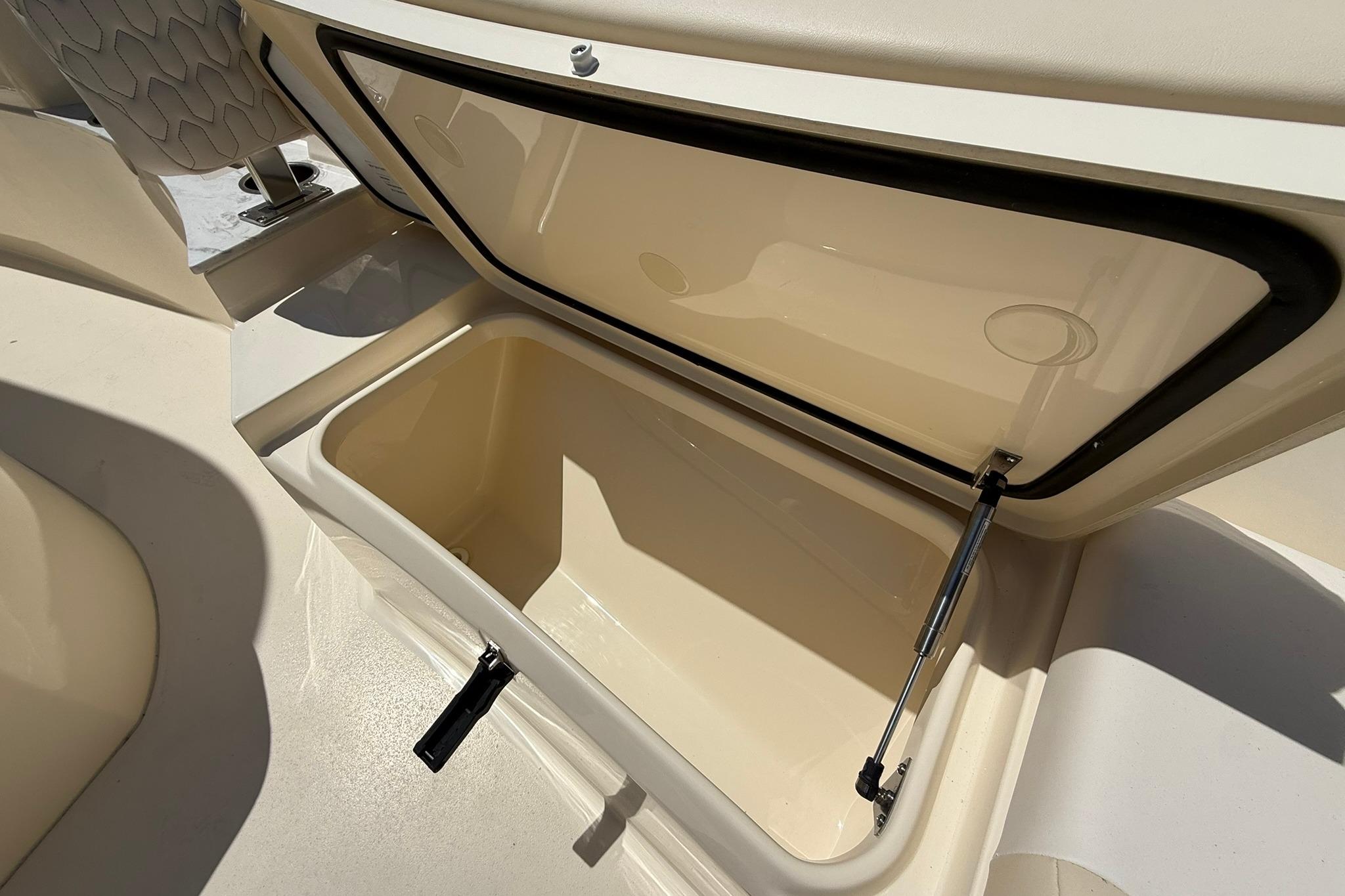 Open storage compartment on 2027 Scout 240 XSF boat, showcasing interior space.