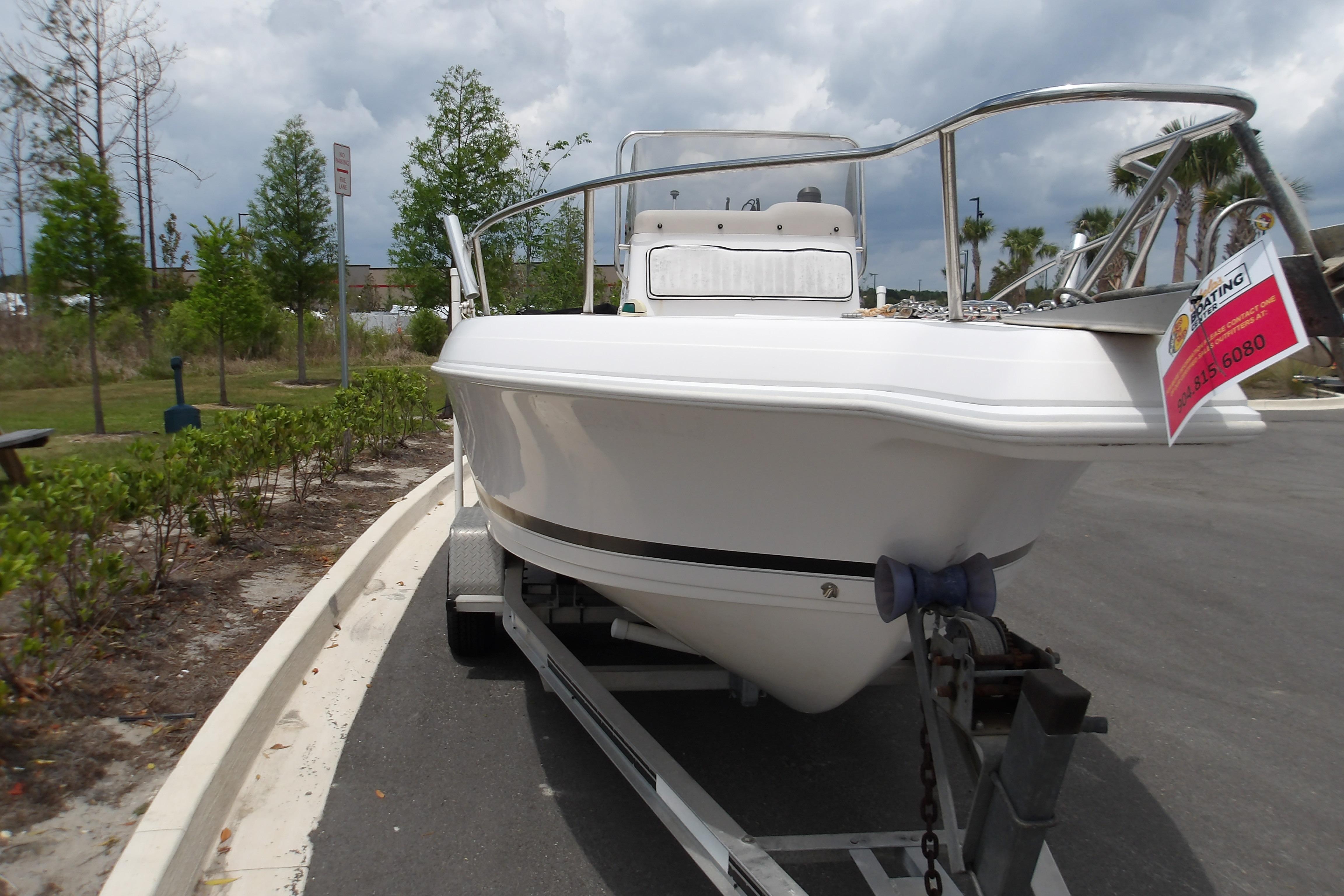 2000 Pro-Line 19 Sport boat on trailer, parked outdoors under cloudy sky.