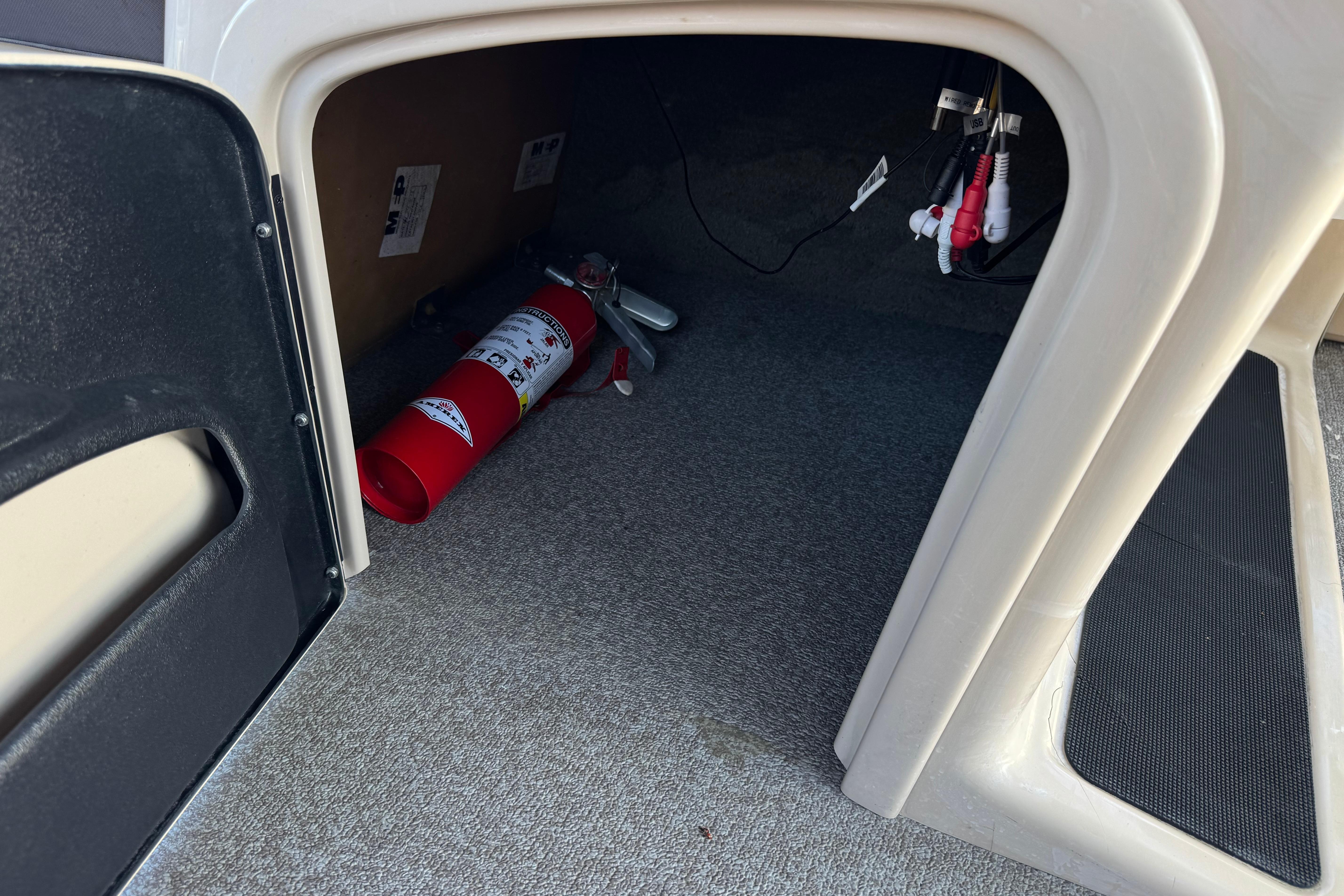 Fire extinguisher inside 2018 Sun Tracker SportFish 22 DLX boat compartment.