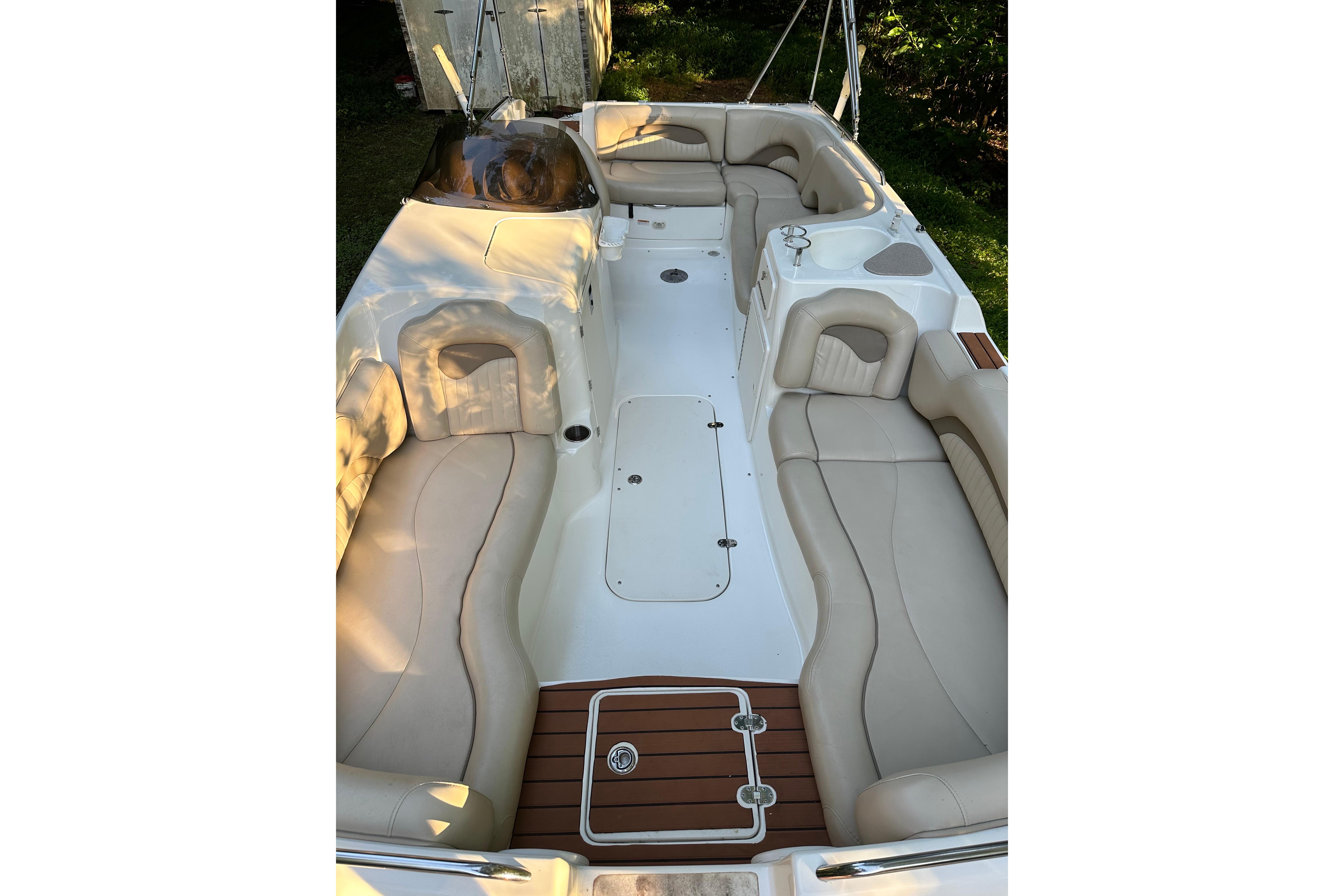 2008 NauticStar 230 SL Sport Deck I/O boat interior with beige seating and white deck.