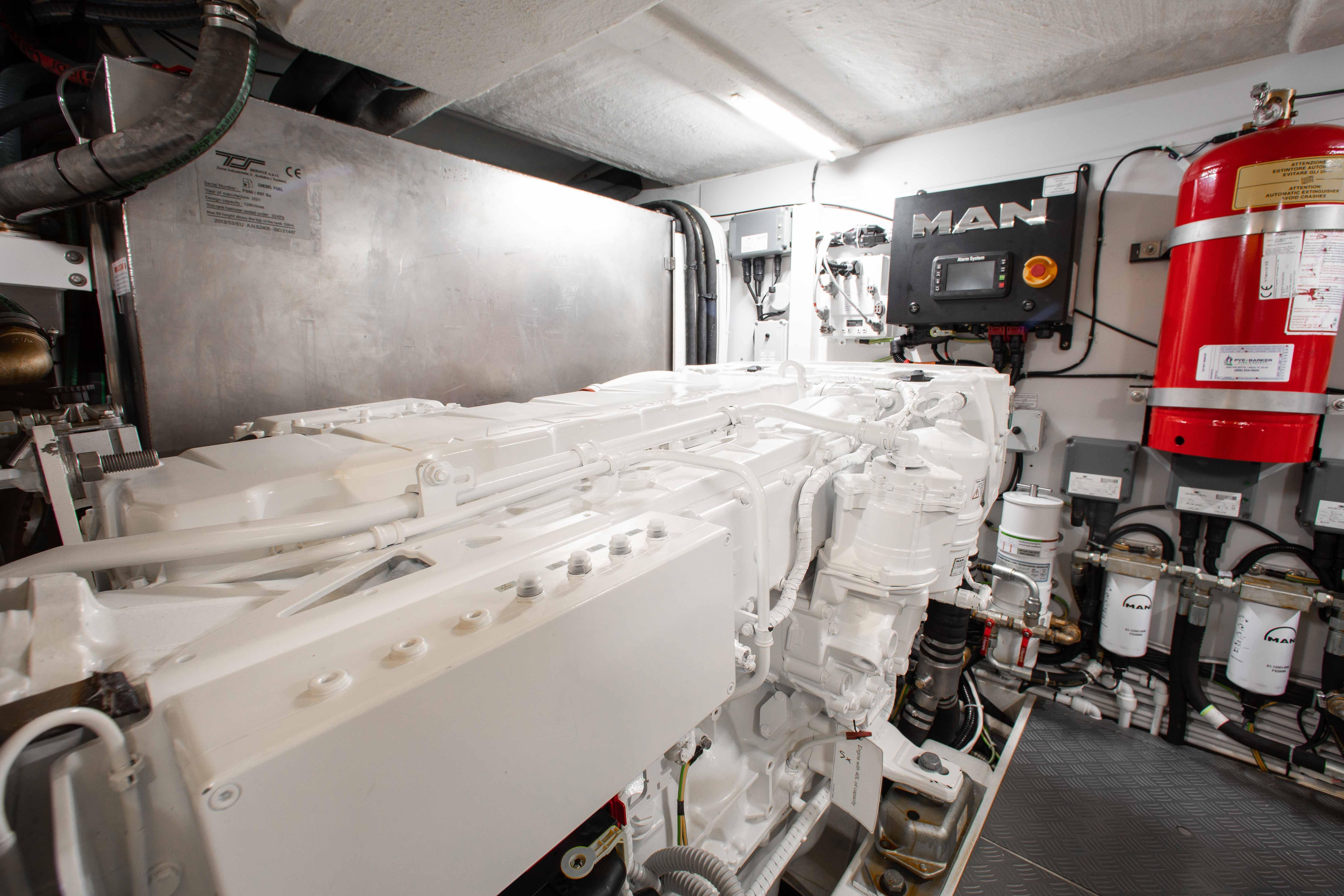 Engine room of 2022 Ferretti Yachts 550, featuring MAN engine and fire suppression system.