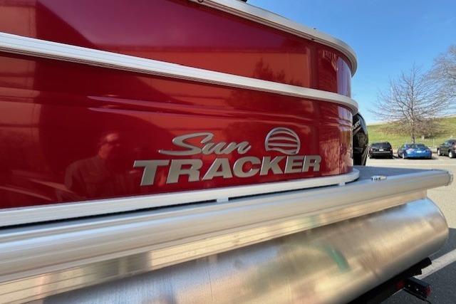 2026 Sun Tracker Party Barge 20 DLX pontoon boat, red exterior, close-up view.
