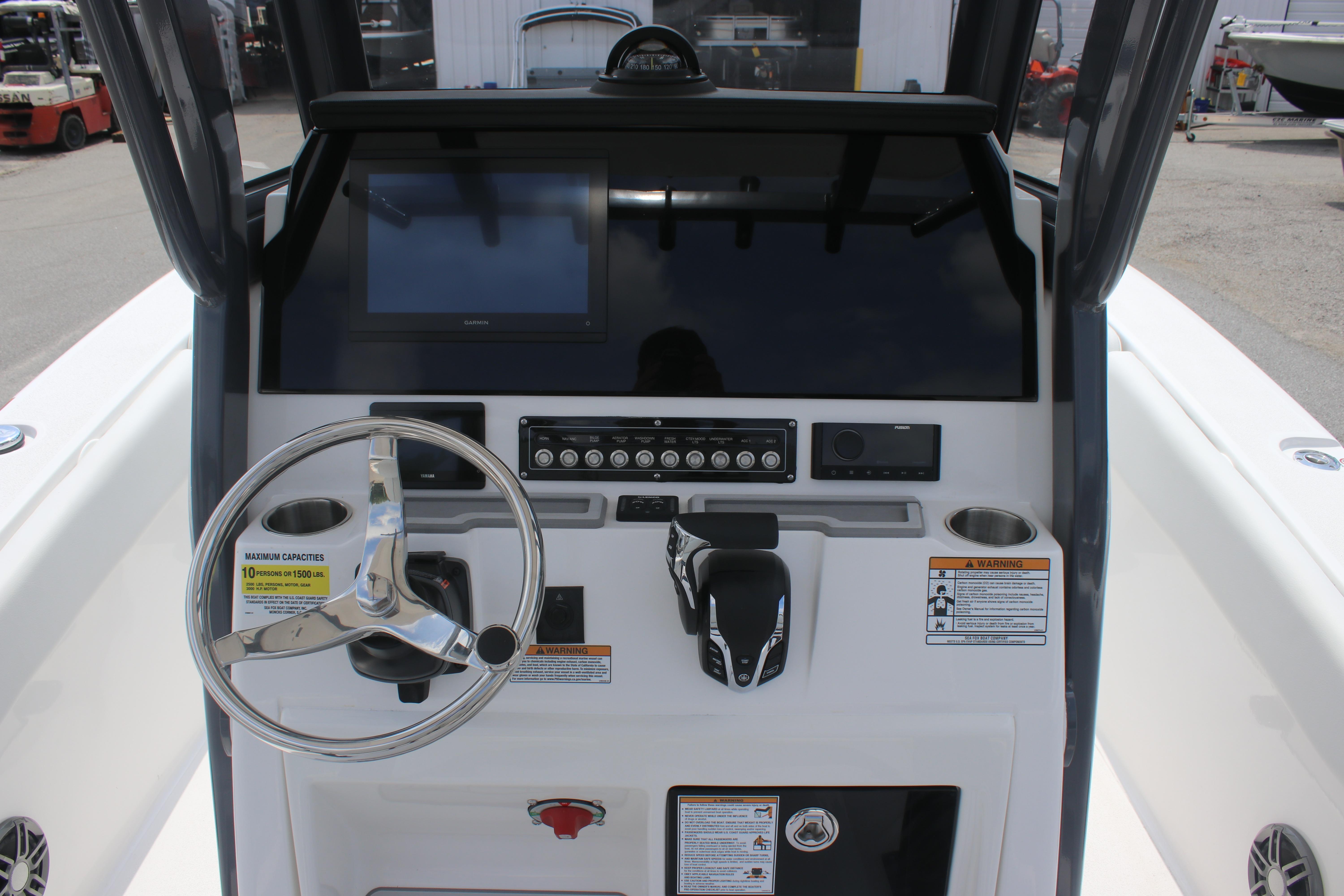 2026 Sea Fox 248 Commander boat dashboard with steering wheel and control panel.