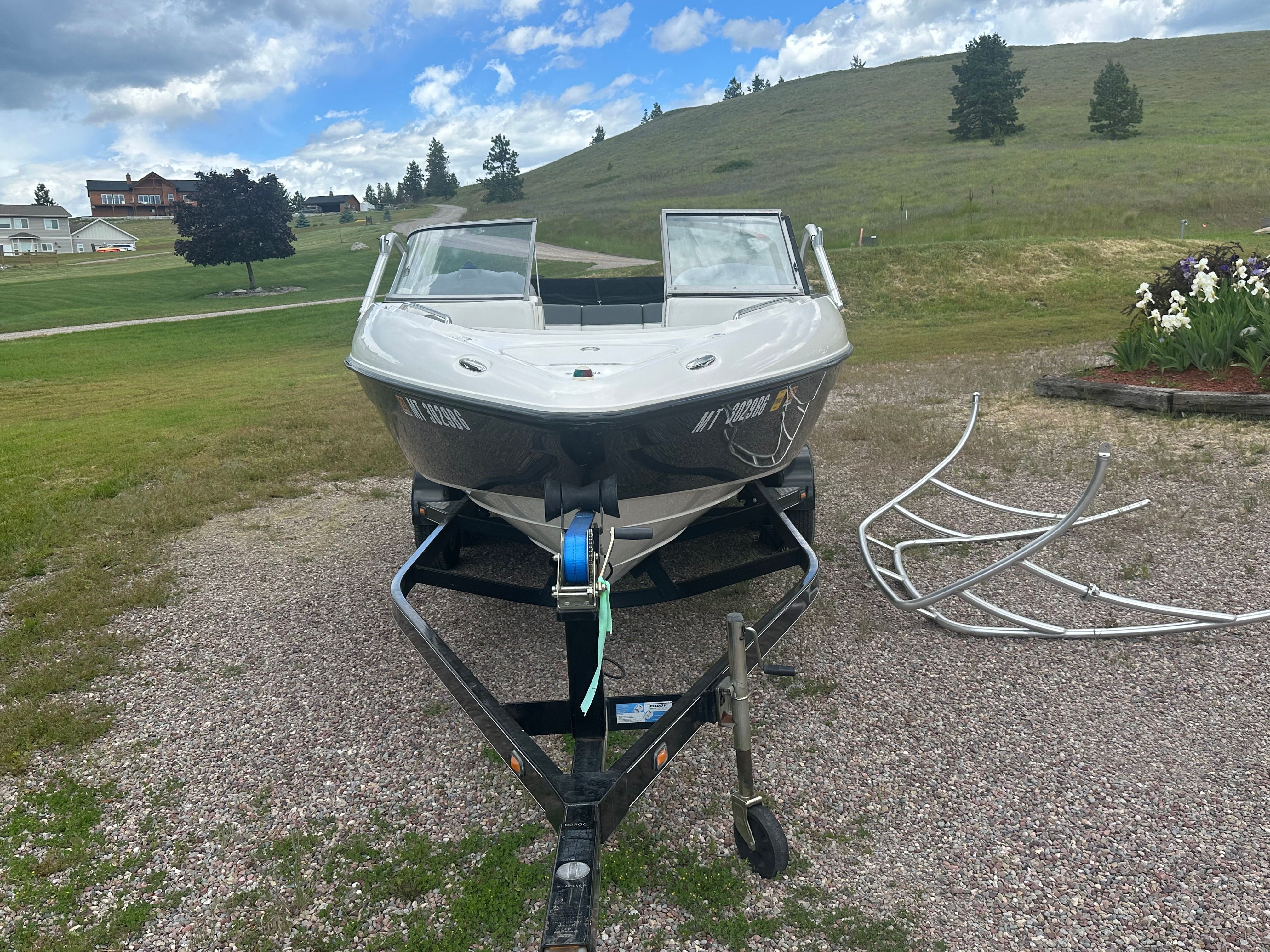 2005 Yamaha AR230 HO boat on trailer, rural setting.