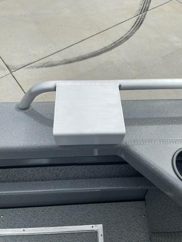 2025 Spartan 200 Astoria boat detail, featuring a sleek gray surface and railing.