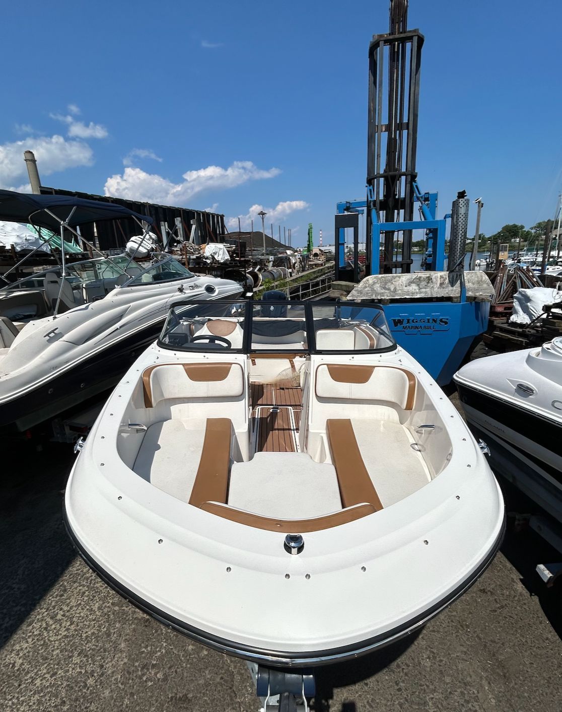2019 Bayliner VR4 Bowrider OB at a dock, featuring brown seating and an open deck.