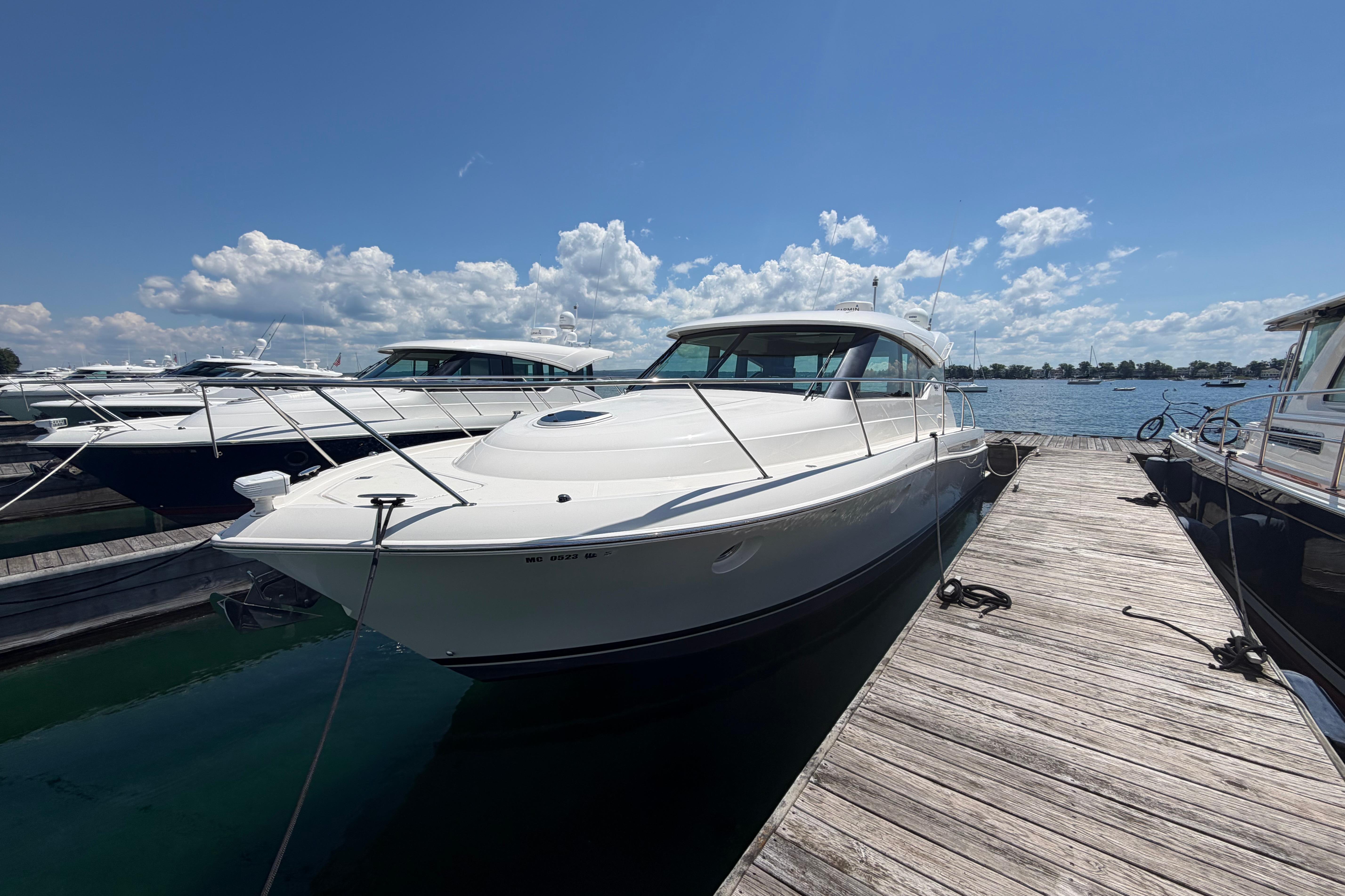 2016 Tiara Yachts C39 Coupe docked under a clear blue sky.