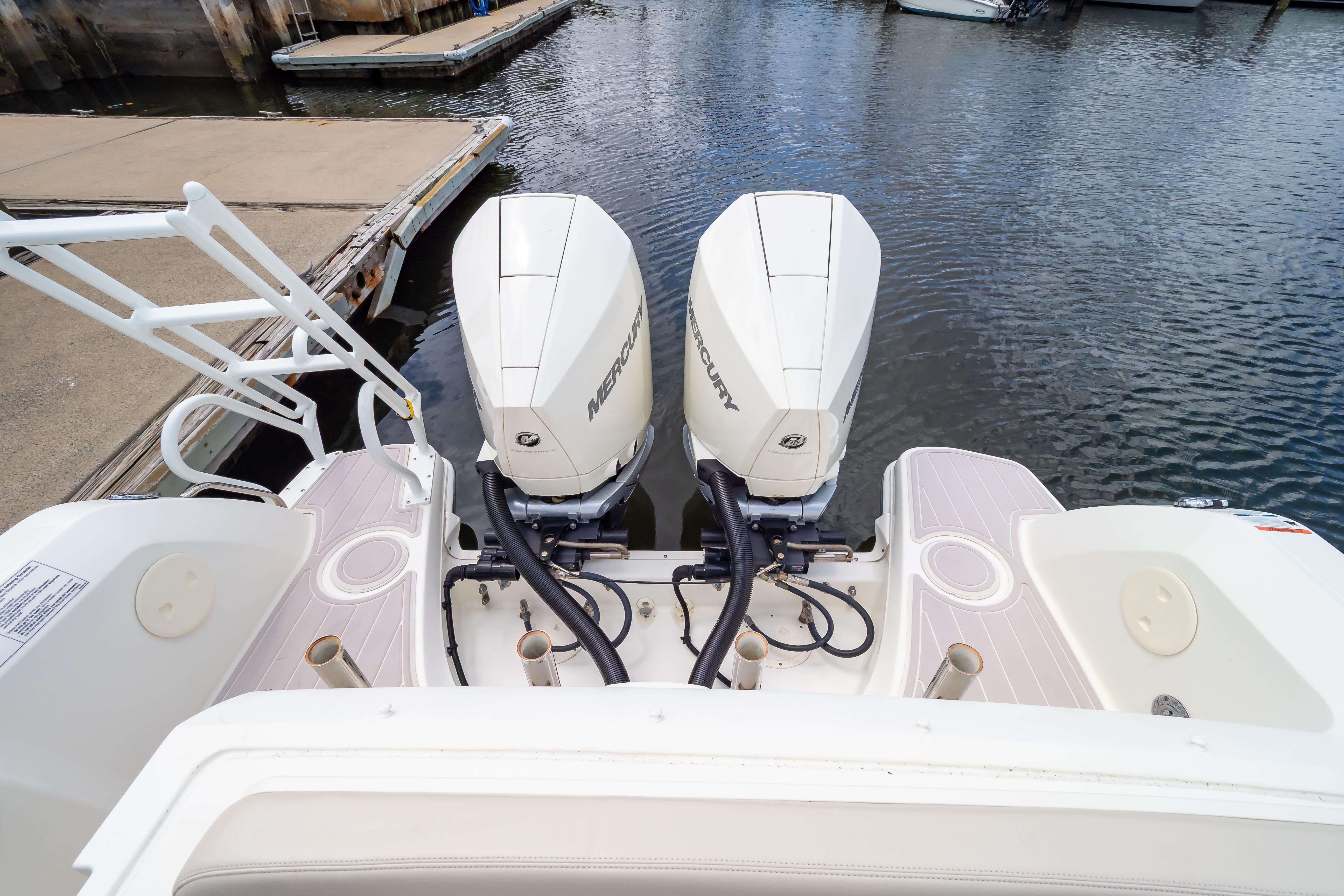 2019 Boston Whaler 270 Vantage with dual Mercury outboard engines at dock.
