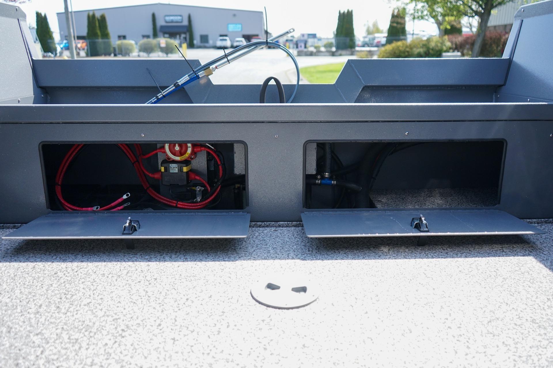 2026 Alumaweld Talon 18 boat storage compartments with visible wiring and equipment.