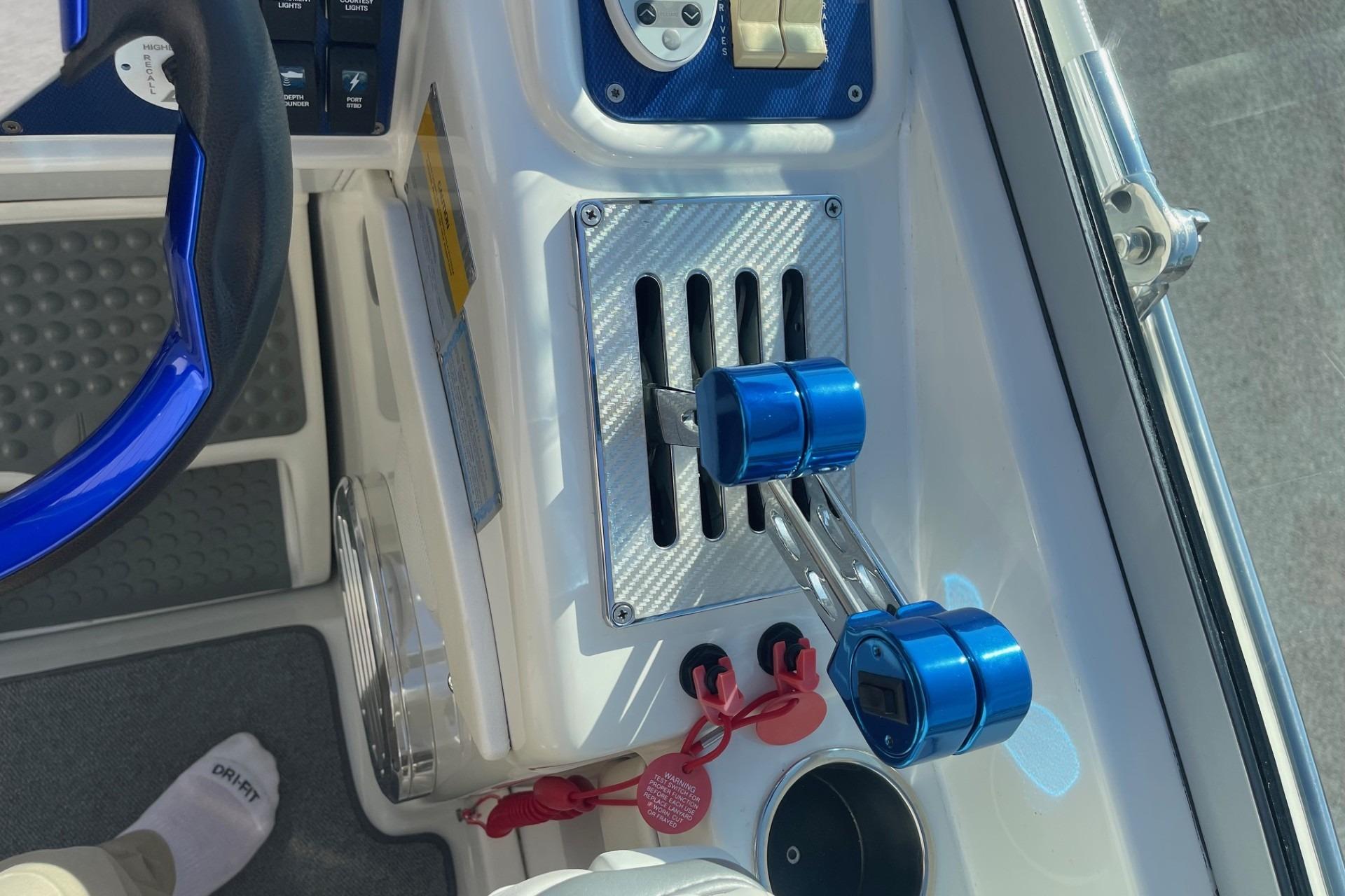 2004 Formula 382 FASTech boat cockpit with blue throttle controls and steering wheel.