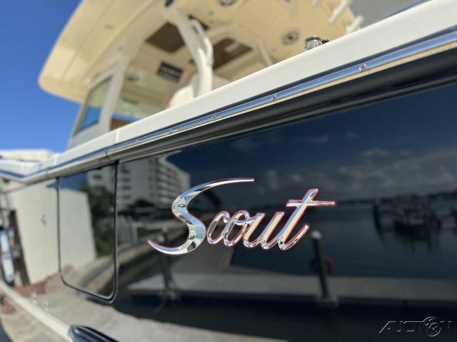 2022 Scout 330 LXF boat docked at marina, close-up of logo.