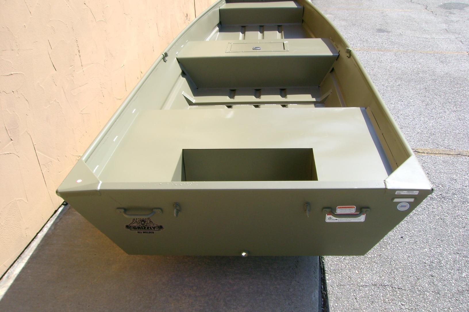 2026 Tracker Grizzly 15 Jon boat, olive green, parked on concrete surface.