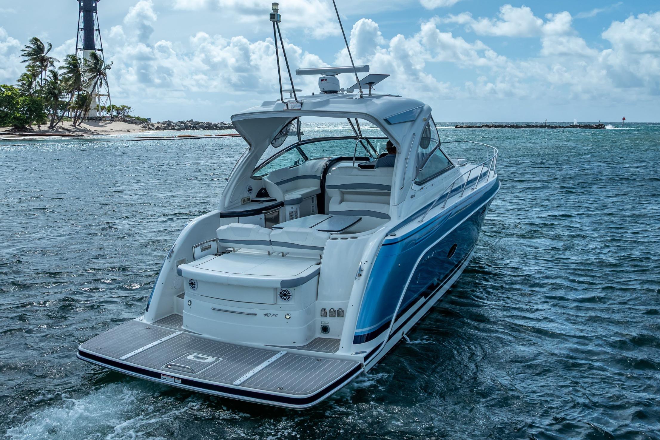 2022 Formula 40 Performance Cruiser on ocean near tropical island and lighthouse.