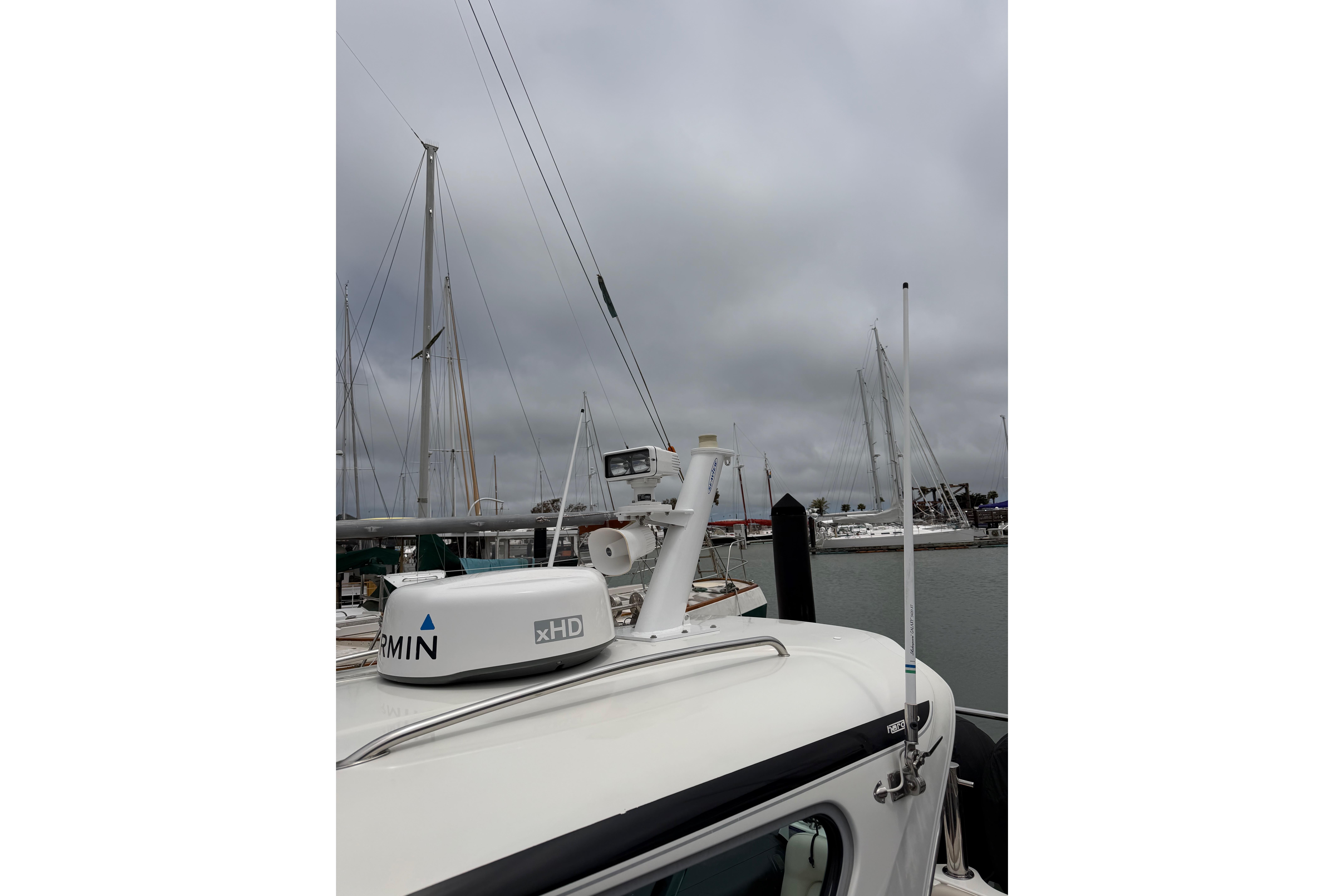 2016 Protector Targa 30 boat docked, featuring Garmin xHD radar, under cloudy skies.