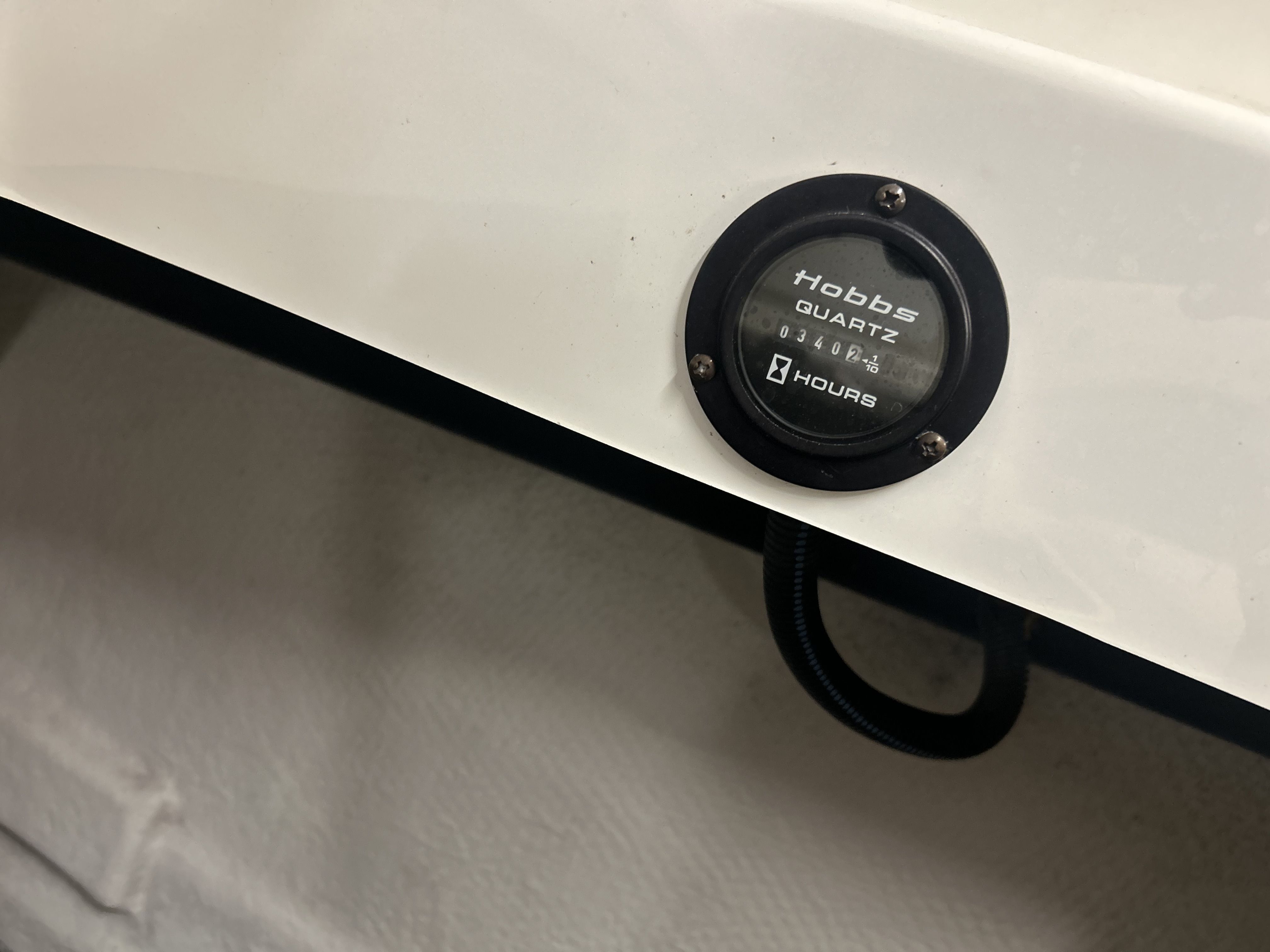 Close-up of a Hobbs Quartz hour meter on a boat.