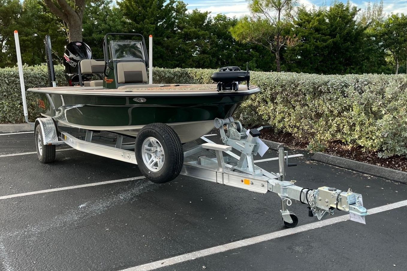 2026 Mako 18 Pro Skiff Backwater Edition on trailer in parking lot.