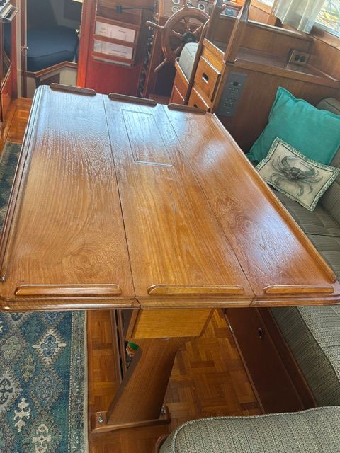 Interior of a 1980 Grand Banks 32 Sedan with wooden table.