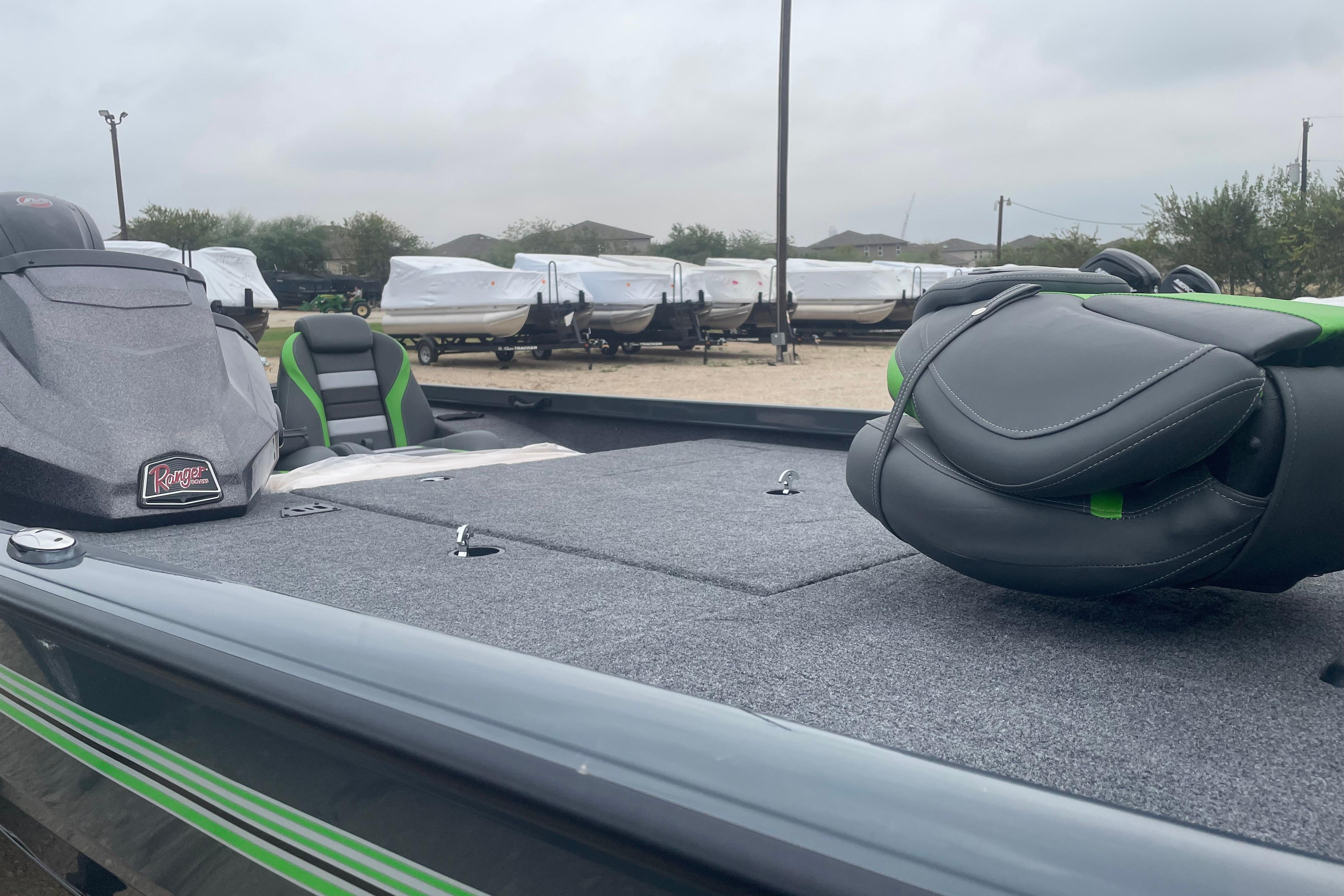 2026 Ranger RT188 boat with green-accented seats, parked outdoors.