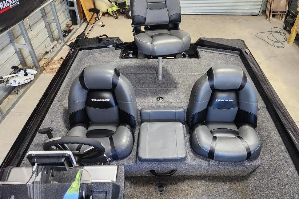 2026 Tracker Pro Team 175 boat interior with gray seating and steering wheel.