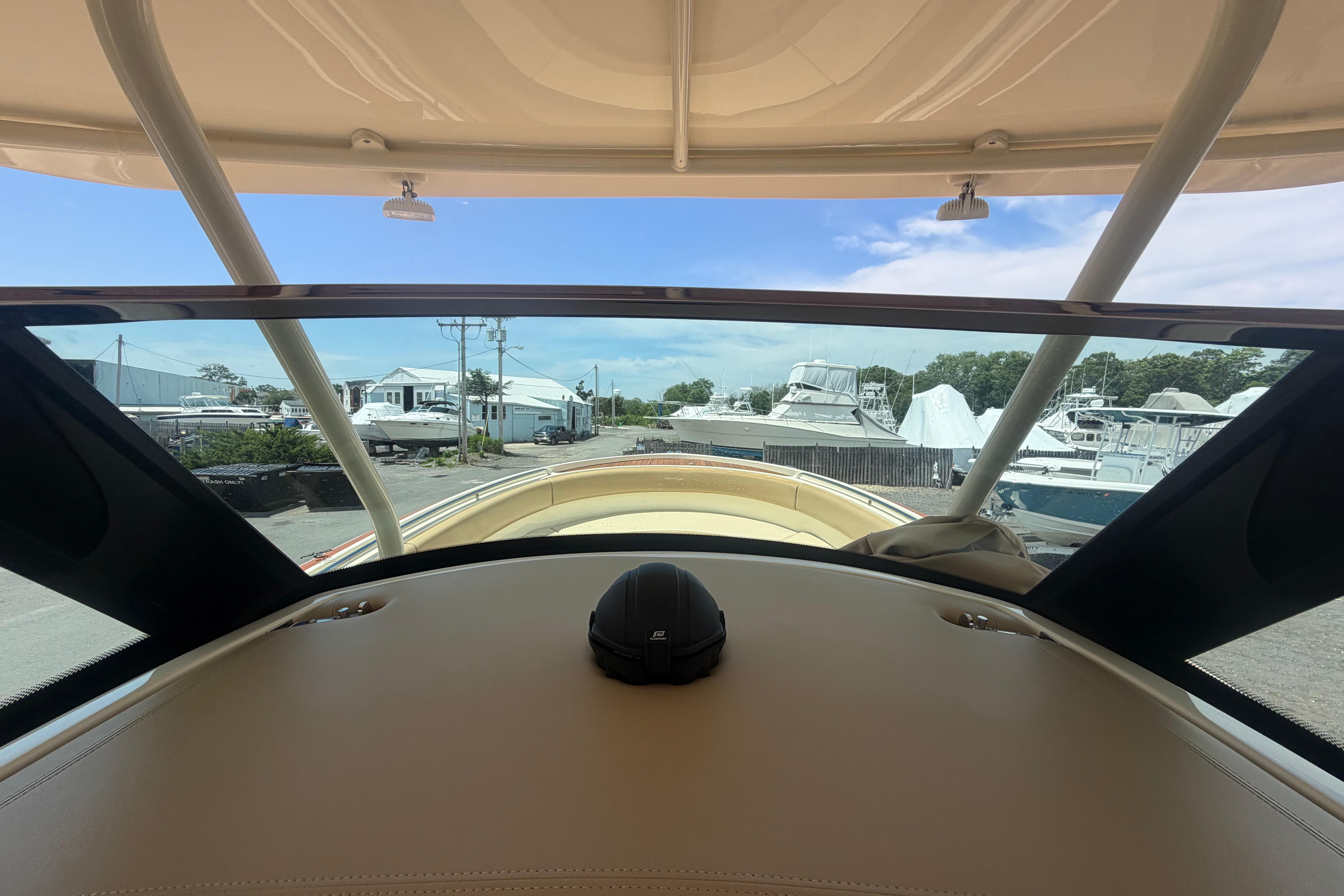 2017 Chris-Craft Catalina 34 boat interior view at a marina, showcasing helm and windshield.