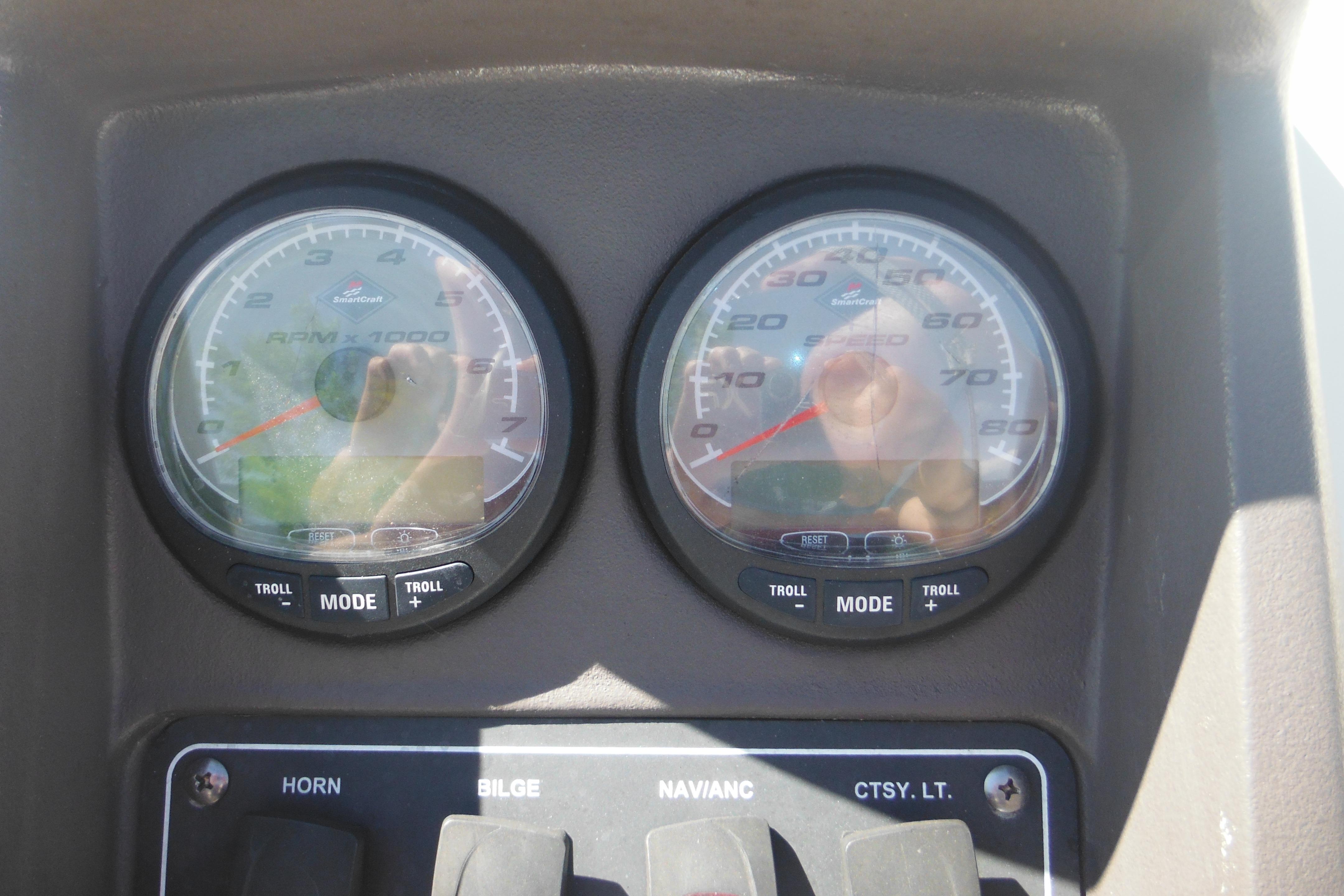 Dashboard of a 2009 Boston Whaler 200 Dauntless boat with gauges and controls.