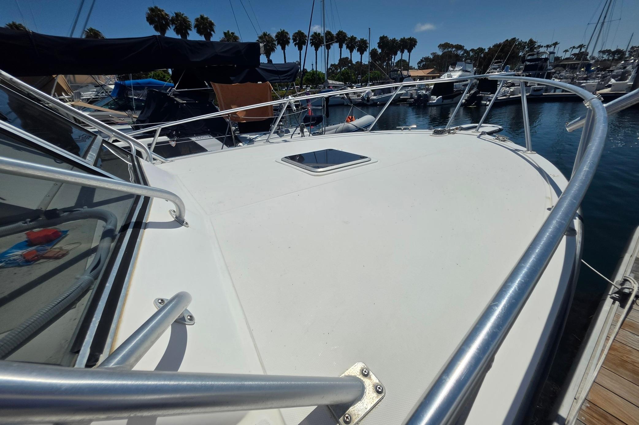 1999 Albemarle 305 Express Fisherman boat docked in a marina, sunny day.