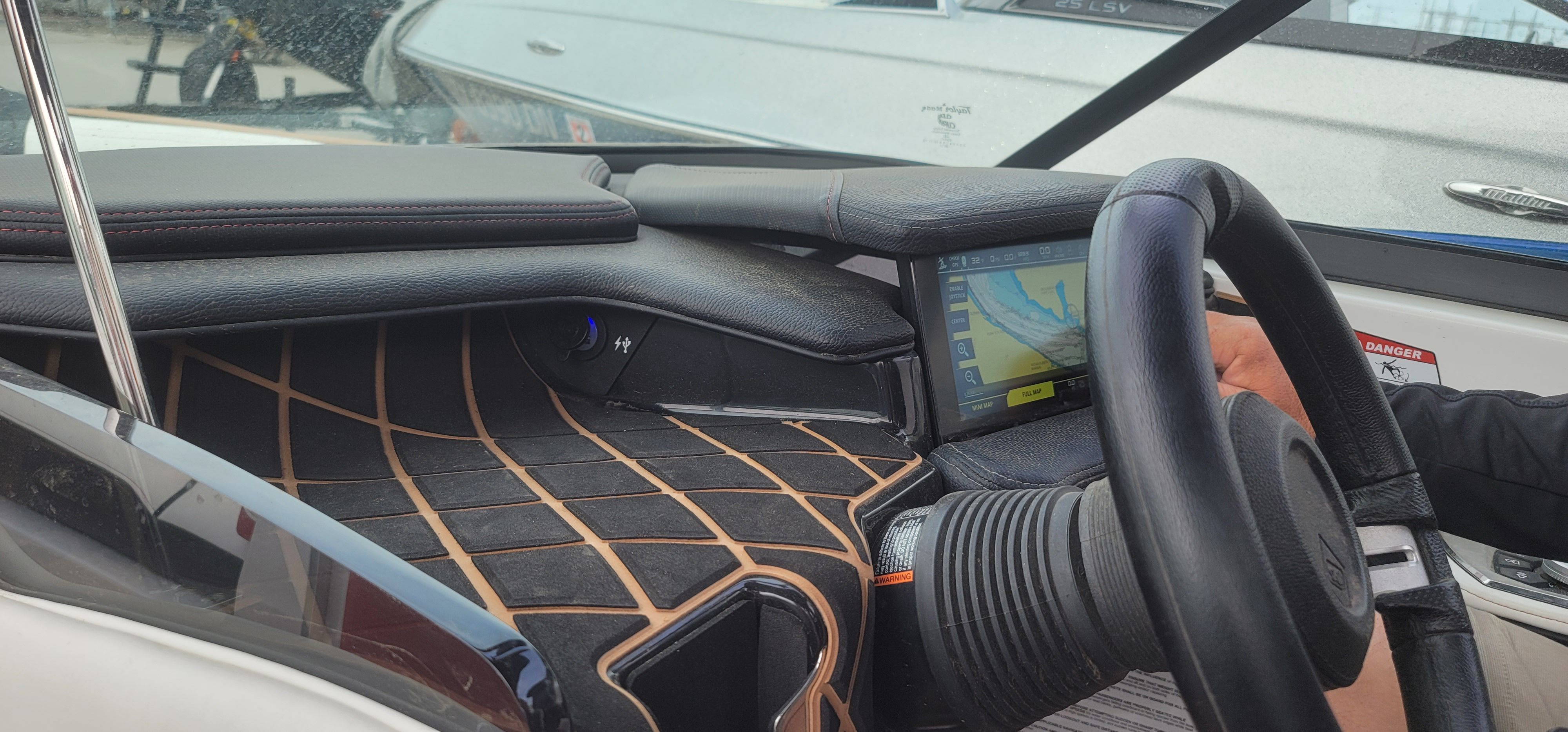 The image shows the cockpit of a 2019 Nautique Super Air Nautique GS22 with a modern display.
