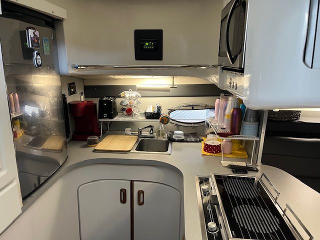 Galley area of a 1989 Trojan 370 Express with sink, stove, and microwave.