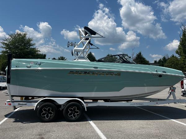2025 Moomba Max boat on trailer, parked outdoors under a blue sky.